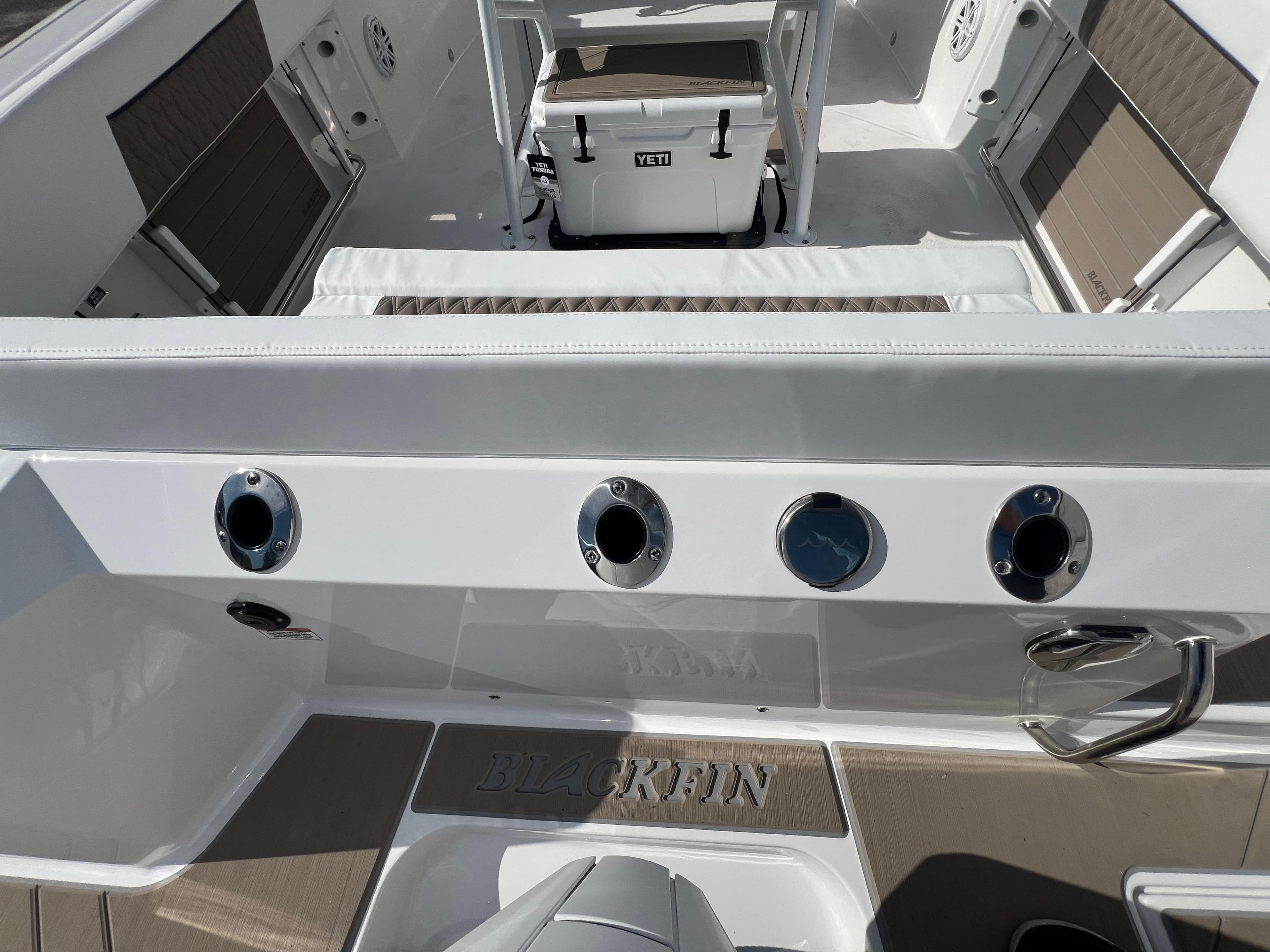 2025 Blackfin 222 CC center console boat interior with rod holders and Yeti cooler.