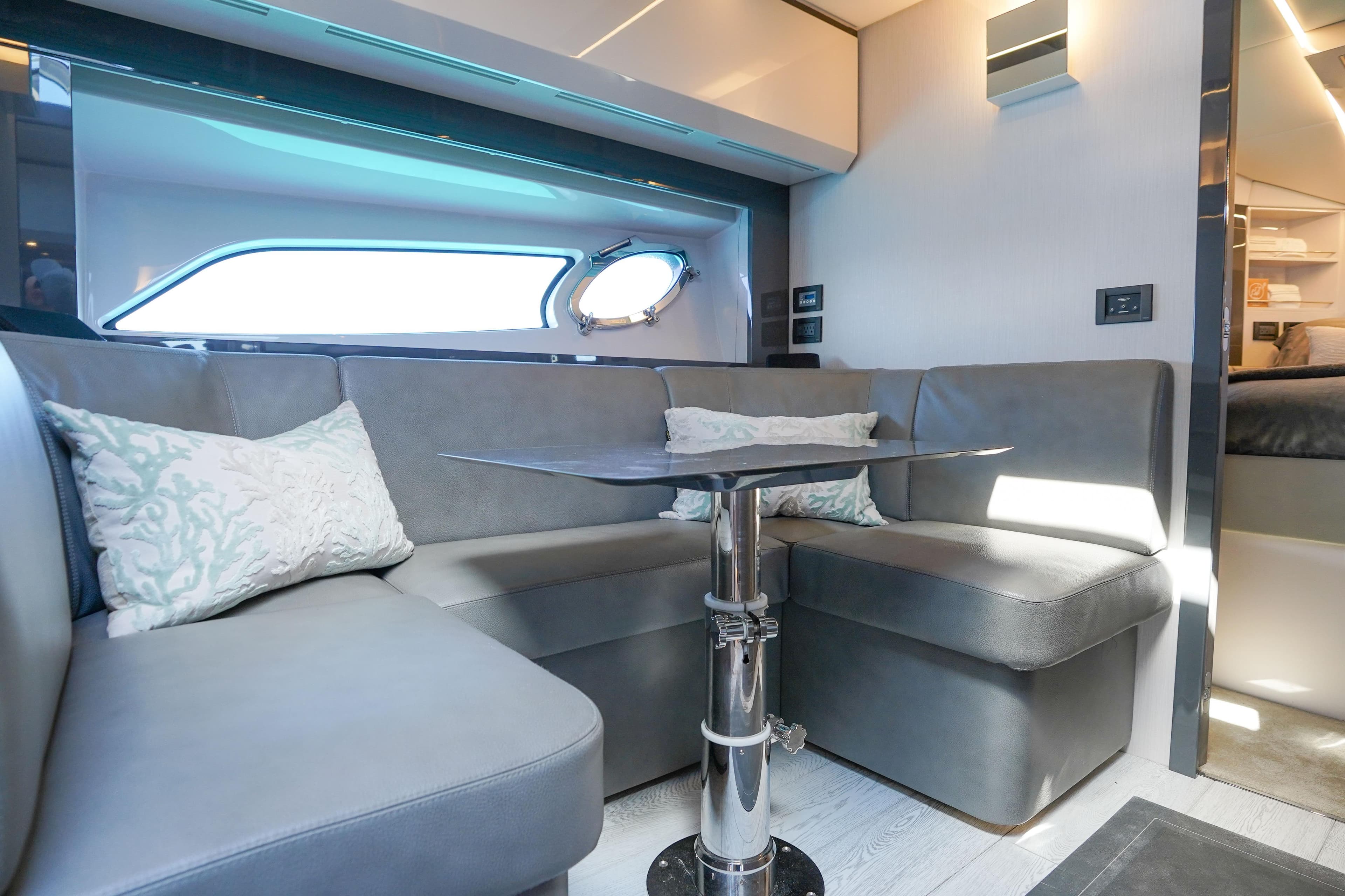 Luxurious interior of 2019 Pershing 5x yacht with modern seating and sleek design.