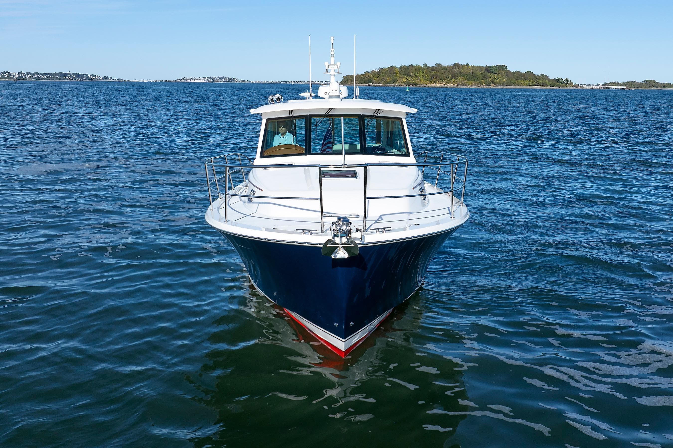 2022 Sabre 38 SE yacht on open water, front view with clear blue sky.