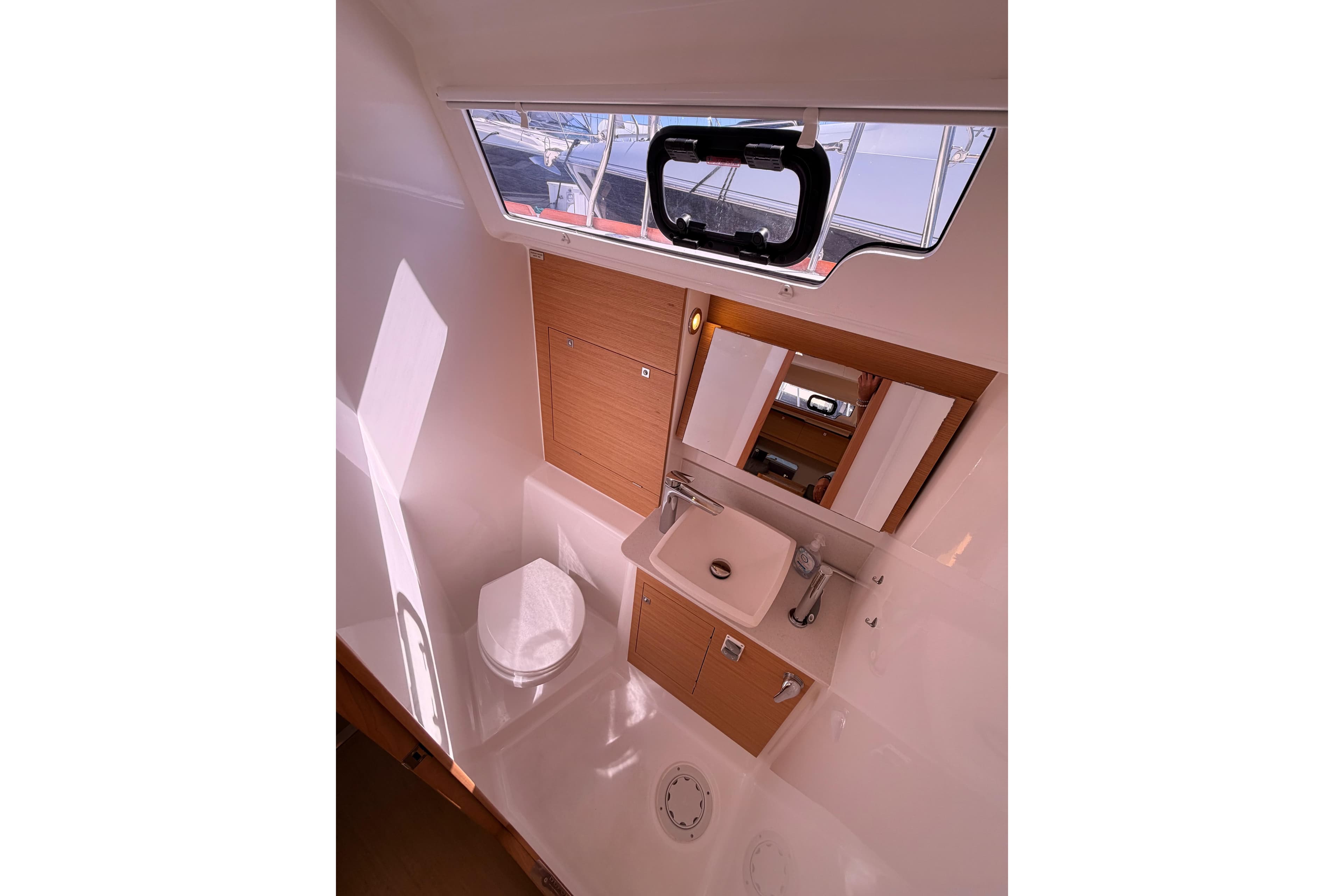 Modern bathroom interior of 2019 Dufour 460 Grand Large yacht with sink and toilet.