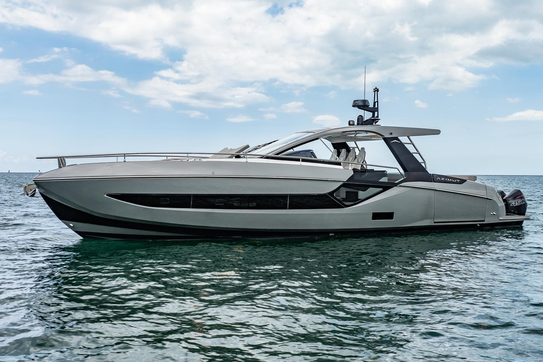 2021 Azimut Verve 47 yacht on calm ocean waters under a partly cloudy sky.