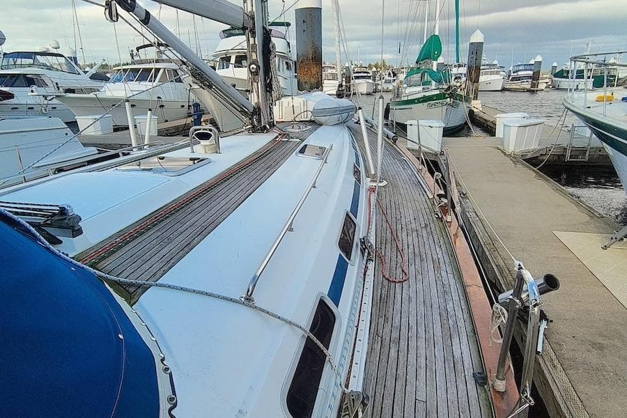 2003 Bavaria 49 sailboat docked at marina, surrounded by other boats.