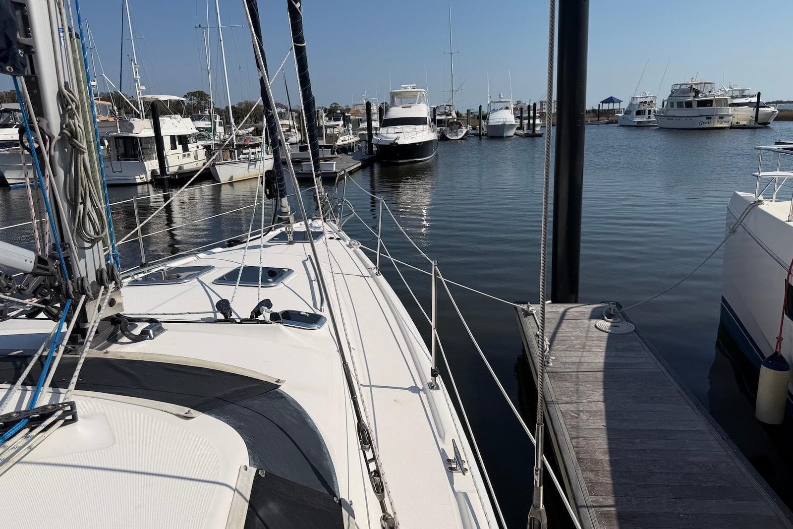 2009 Hunter 50 Center Cockpit sailboat docked in a marina with other boats.