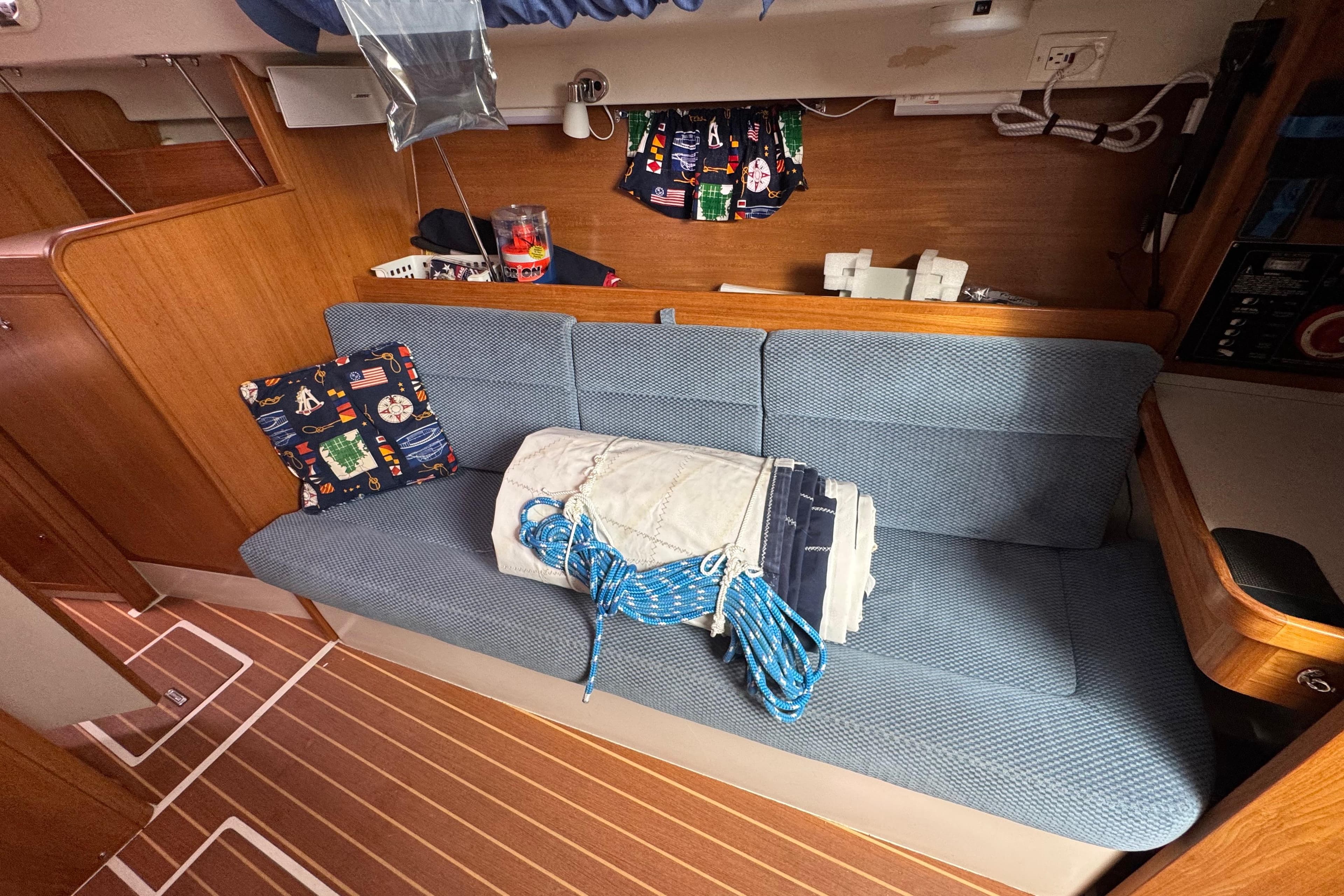 Interior of a 2006 Catalina 309 sailboat with blue seating and nautical decor.