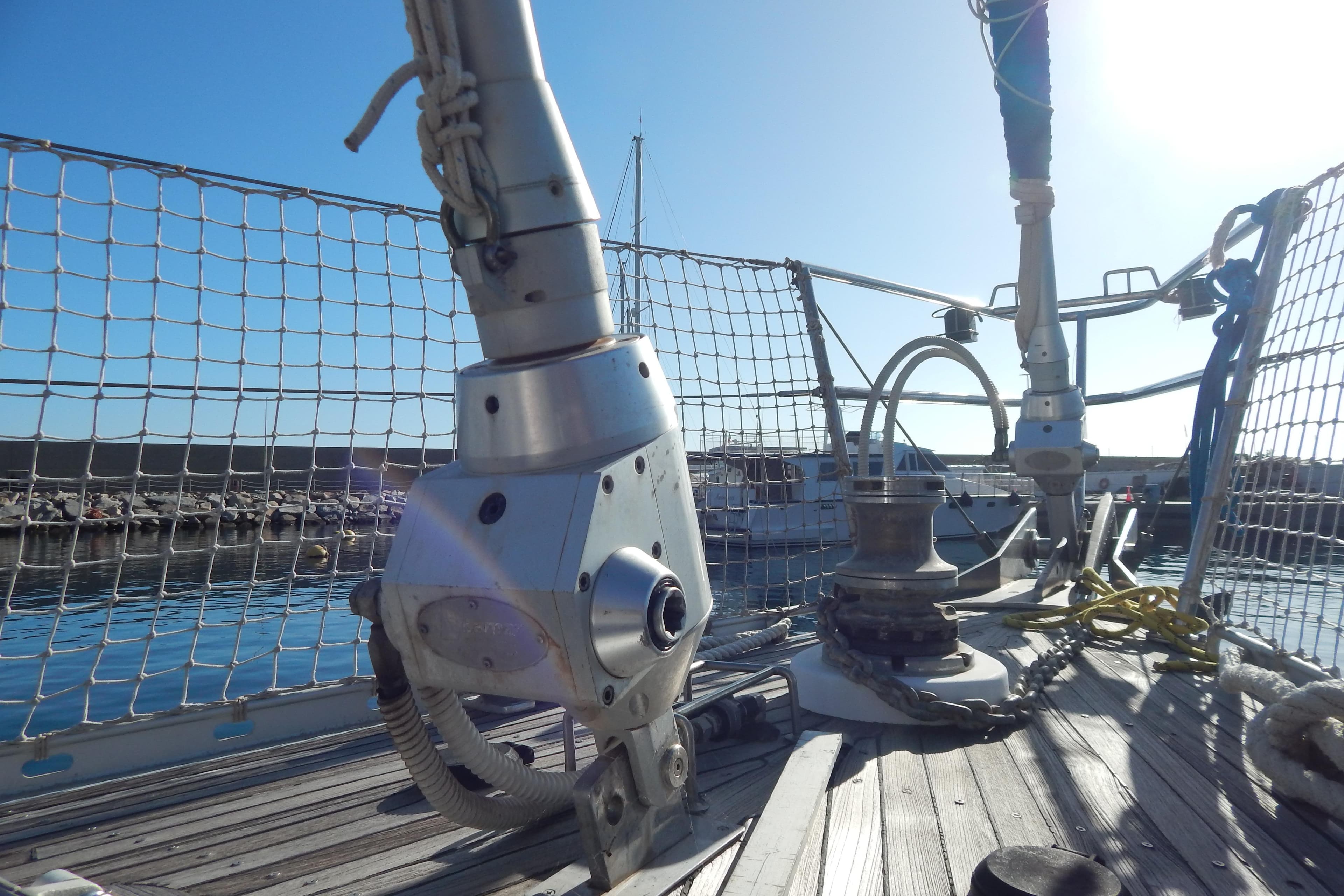 Deck view of a 1992 Tayana 55 sailboat, featuring rigging and winch details.