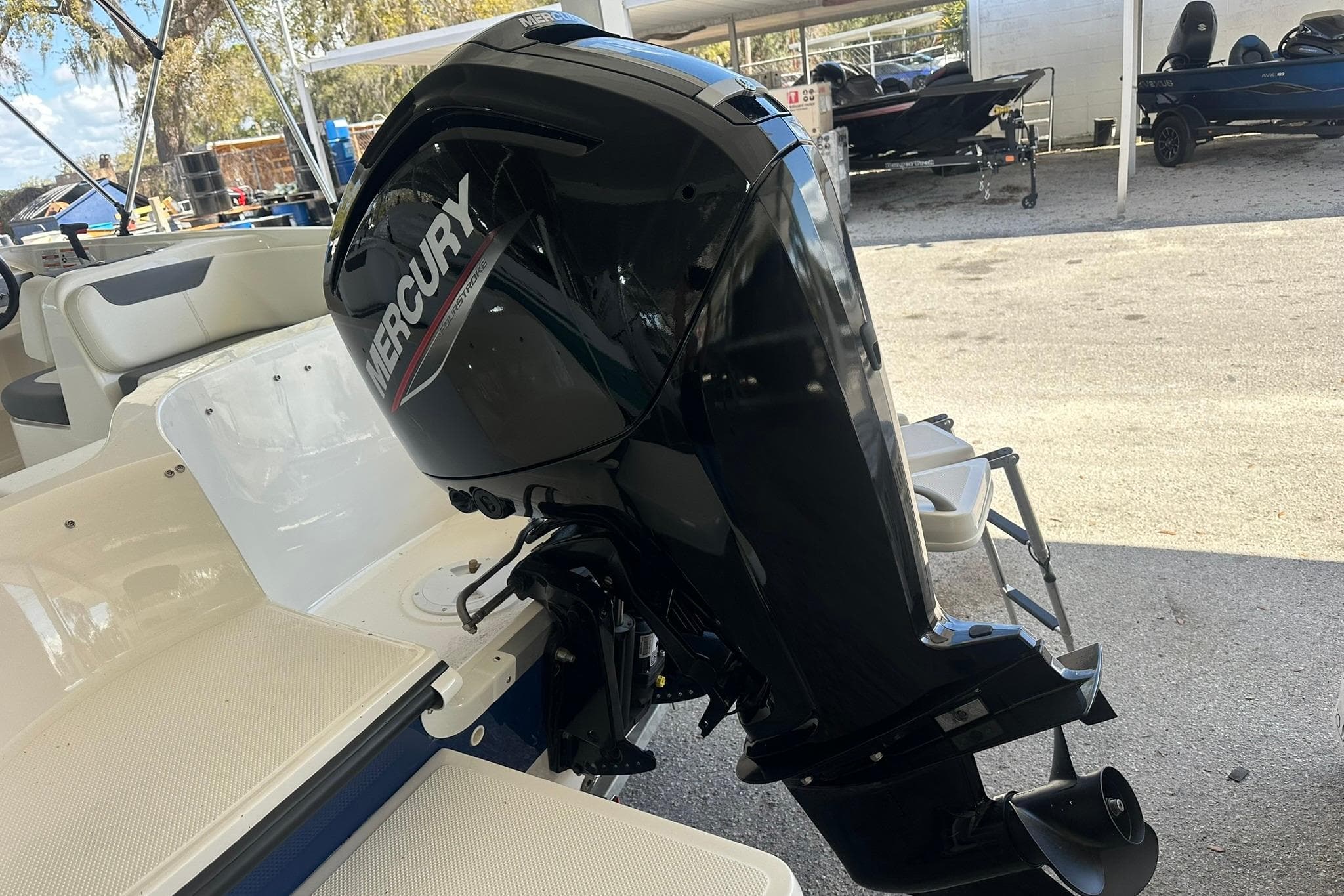 2025 Bayliner Element E18 with Mercury outboard motor in a marina setting.