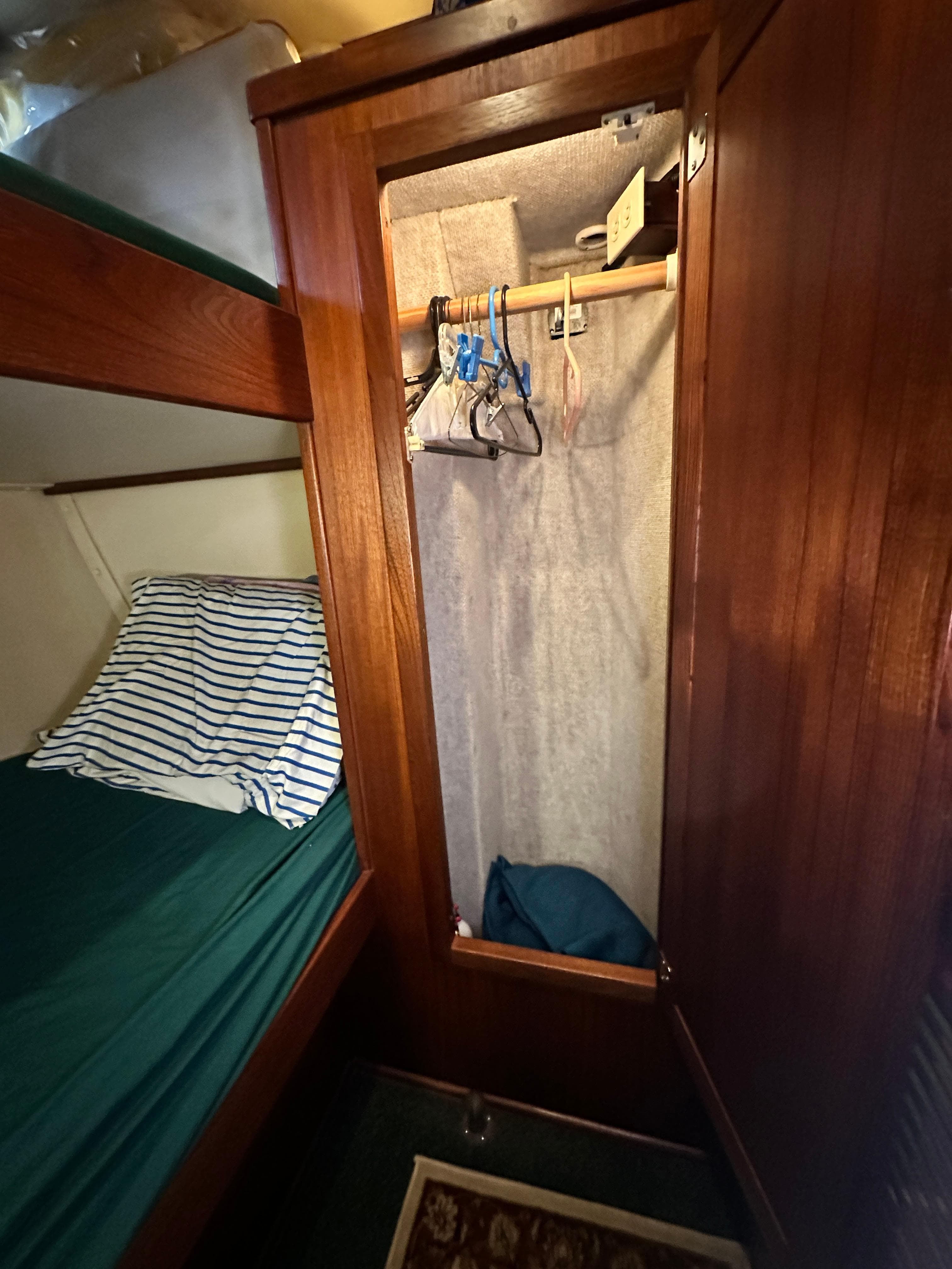 Wooden closet and bunk bed in 2001 Nordic Tug 37 boat interior.