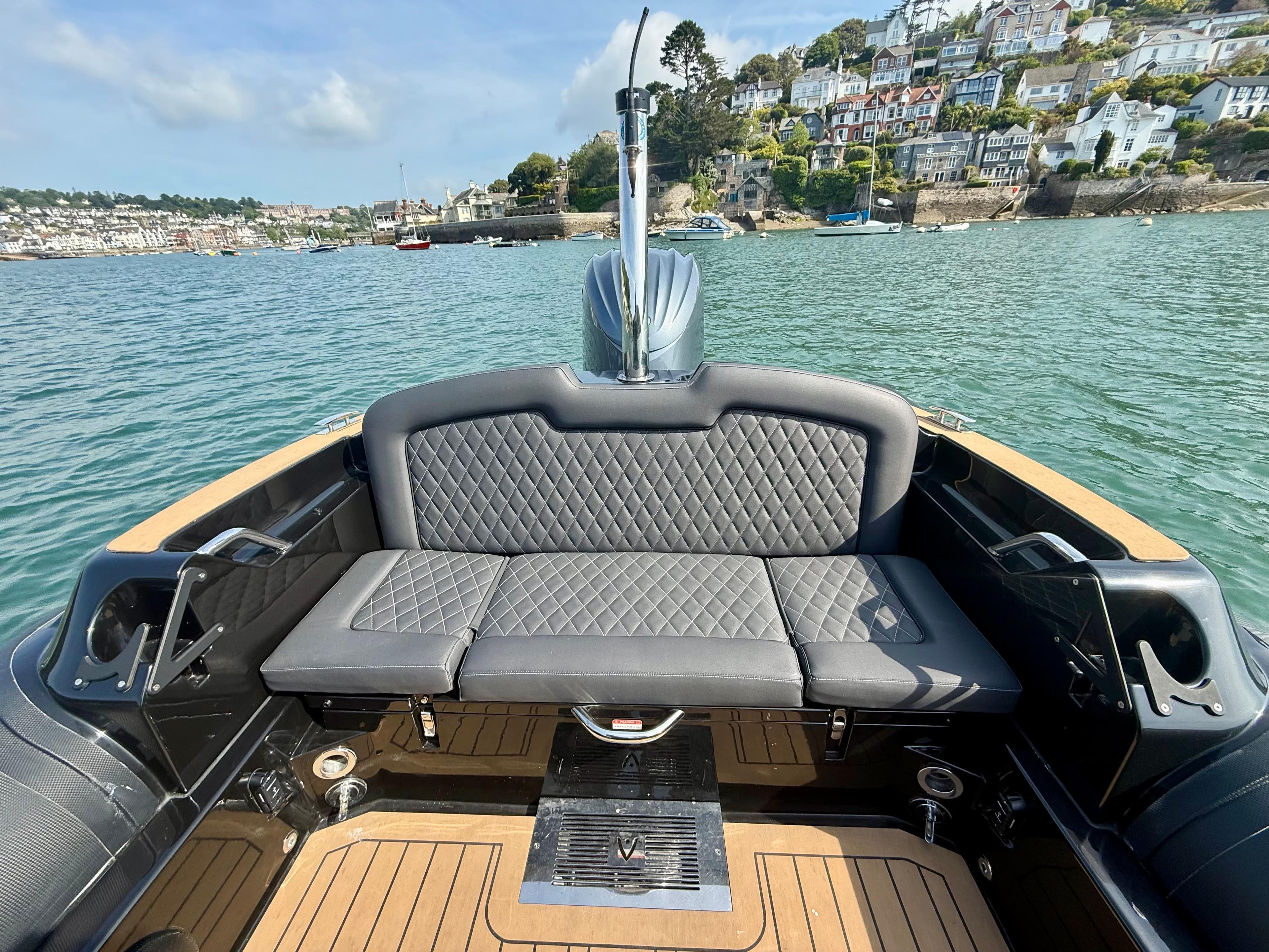 2023 Ribeye A683 boat with cushioned seating on calm waters.