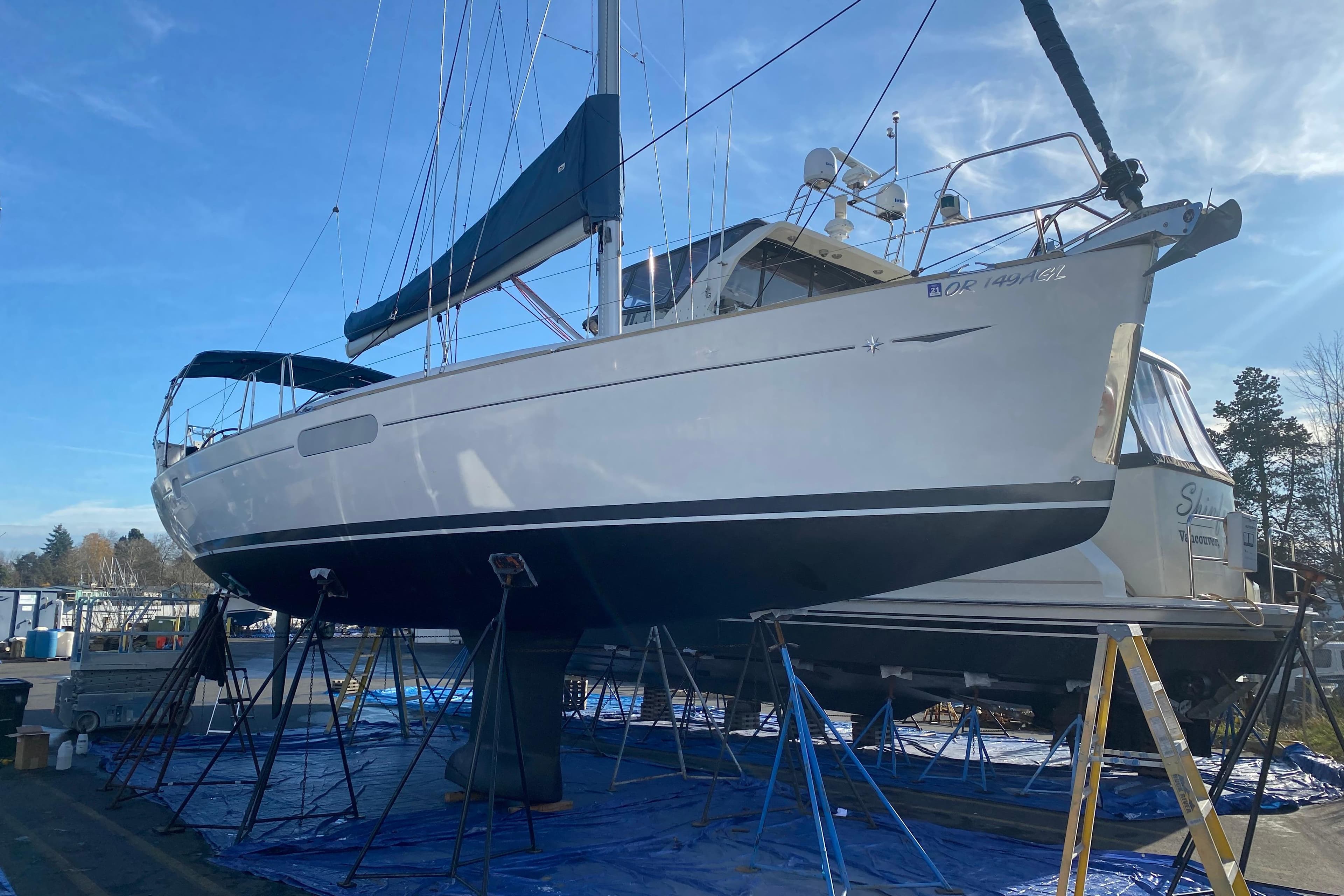 Jeanneau Sun Odyssey 44i sailboat from 2010 on stands in a marina.