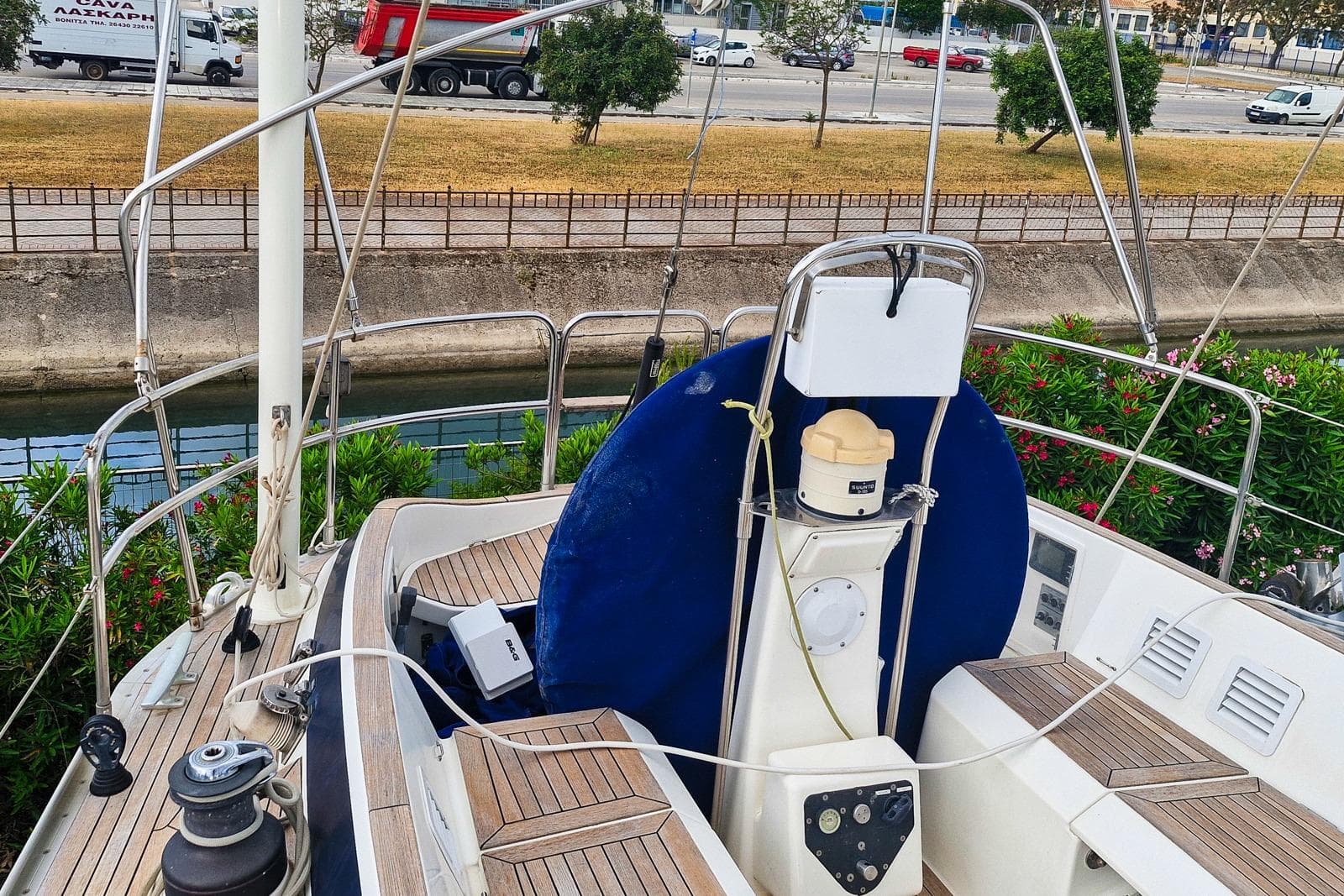 Deck view of a 2002 Nautor Swan 44 yacht with wooden flooring and steering equipment.