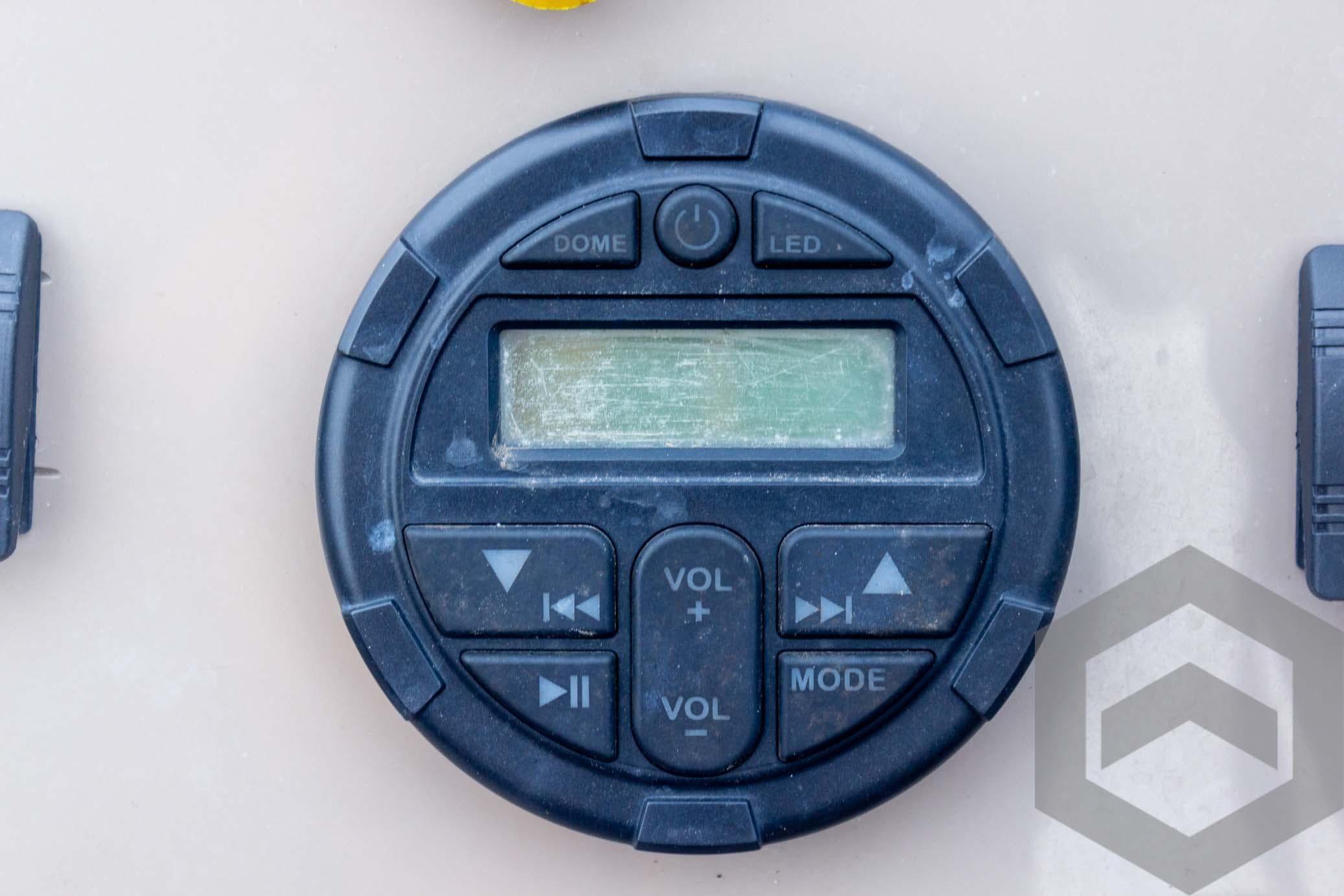 Control panel of 2020 Sun Tracker Fishin' Barge 22 DLX with volume and mode buttons.