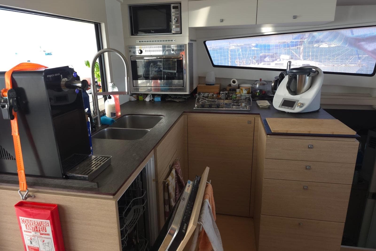 Modern kitchen inside a 2016 Bali 4.5 yacht, featuring appliances and ample storage.