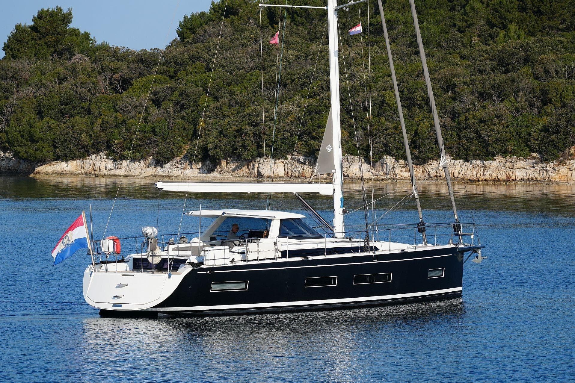Sailing yacht Amel 50, 2017 model, anchored in serene coastal waters.
