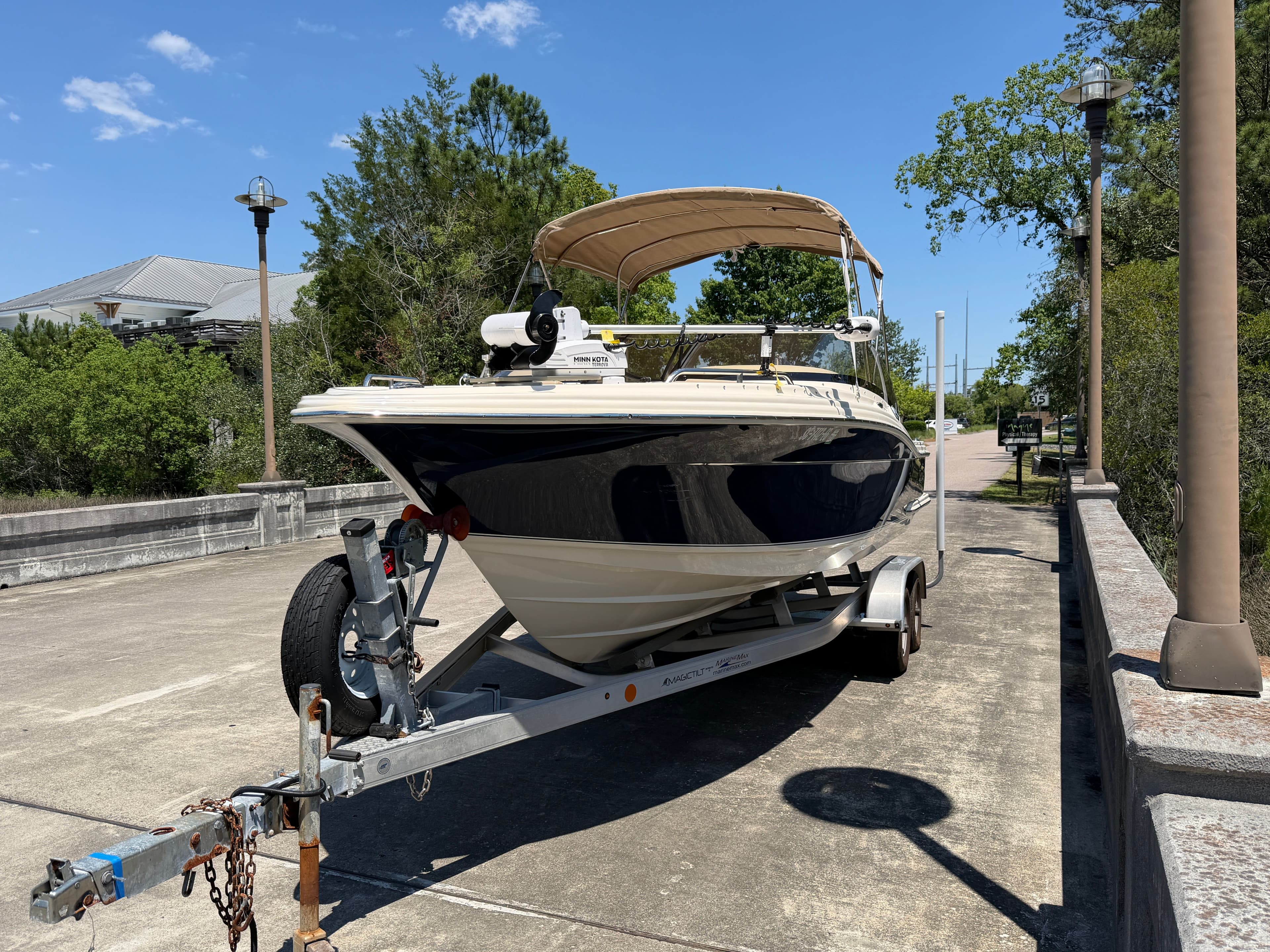 2024 Scout 215 Dorado boat on trailer in sunny weather.