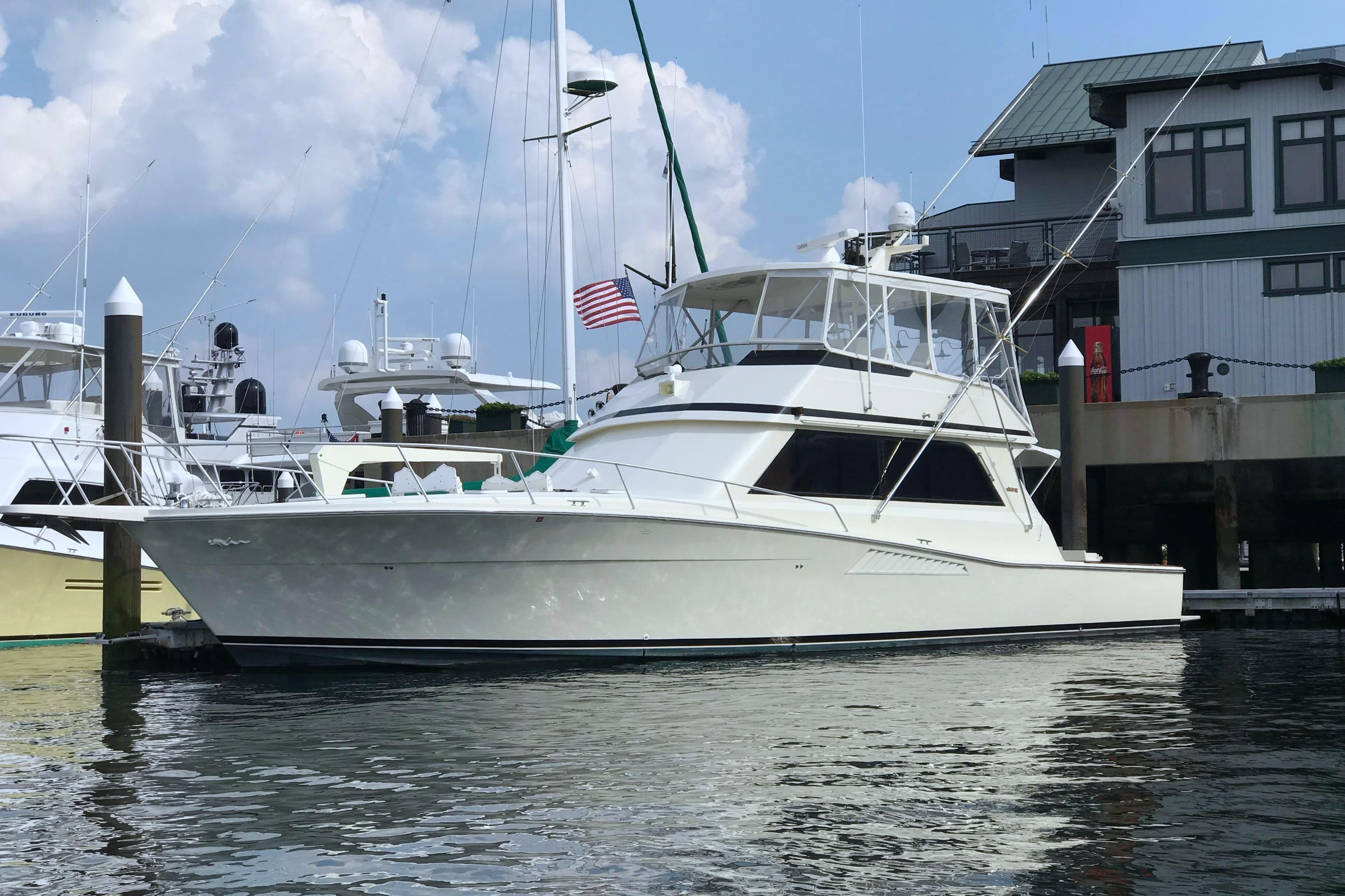 1991 Viking 53 Convertible yacht docked at marina, clear sky background.