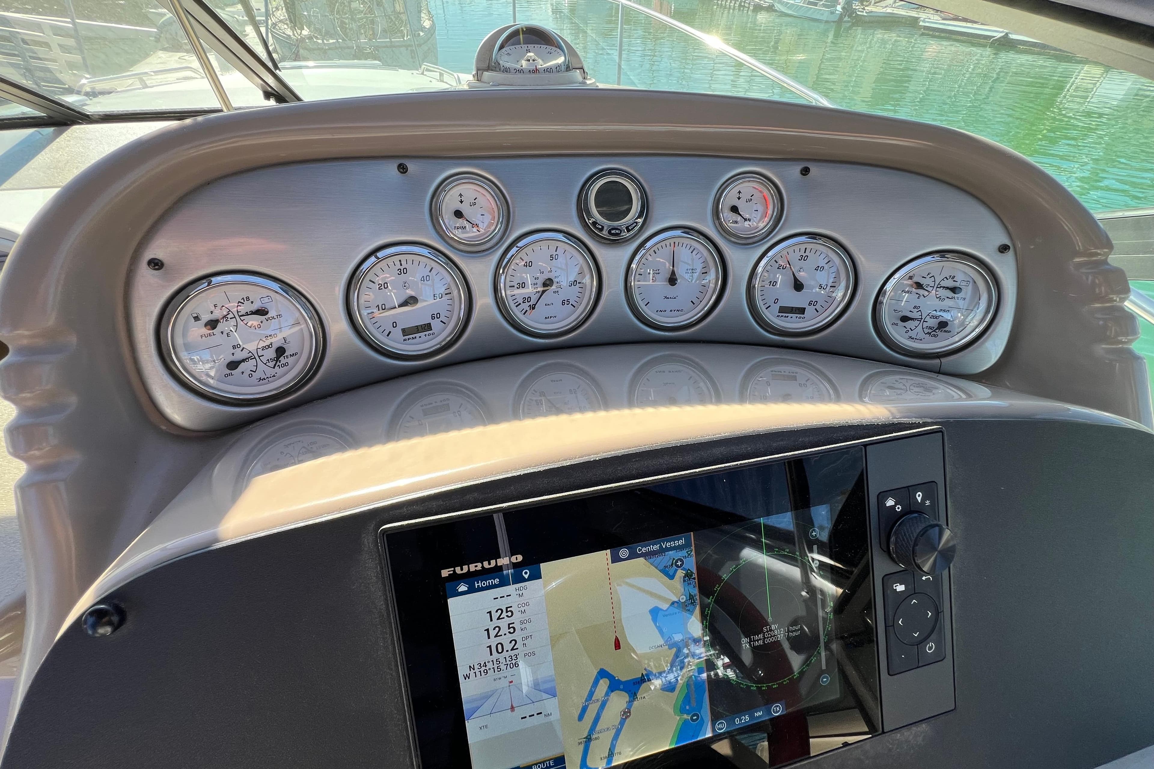 Dashboard of a 2007 Larson Cabrio 310 boat with gauges and navigation display.