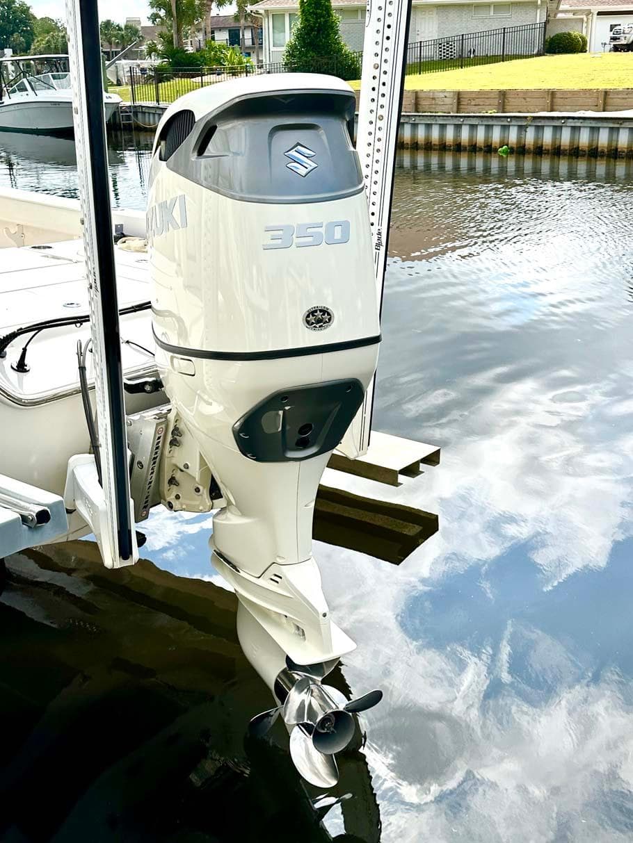 2020 Blue Wave 2800 Pure Hybrid boat with Suzuki 350 outboard motor on a calm waterway.