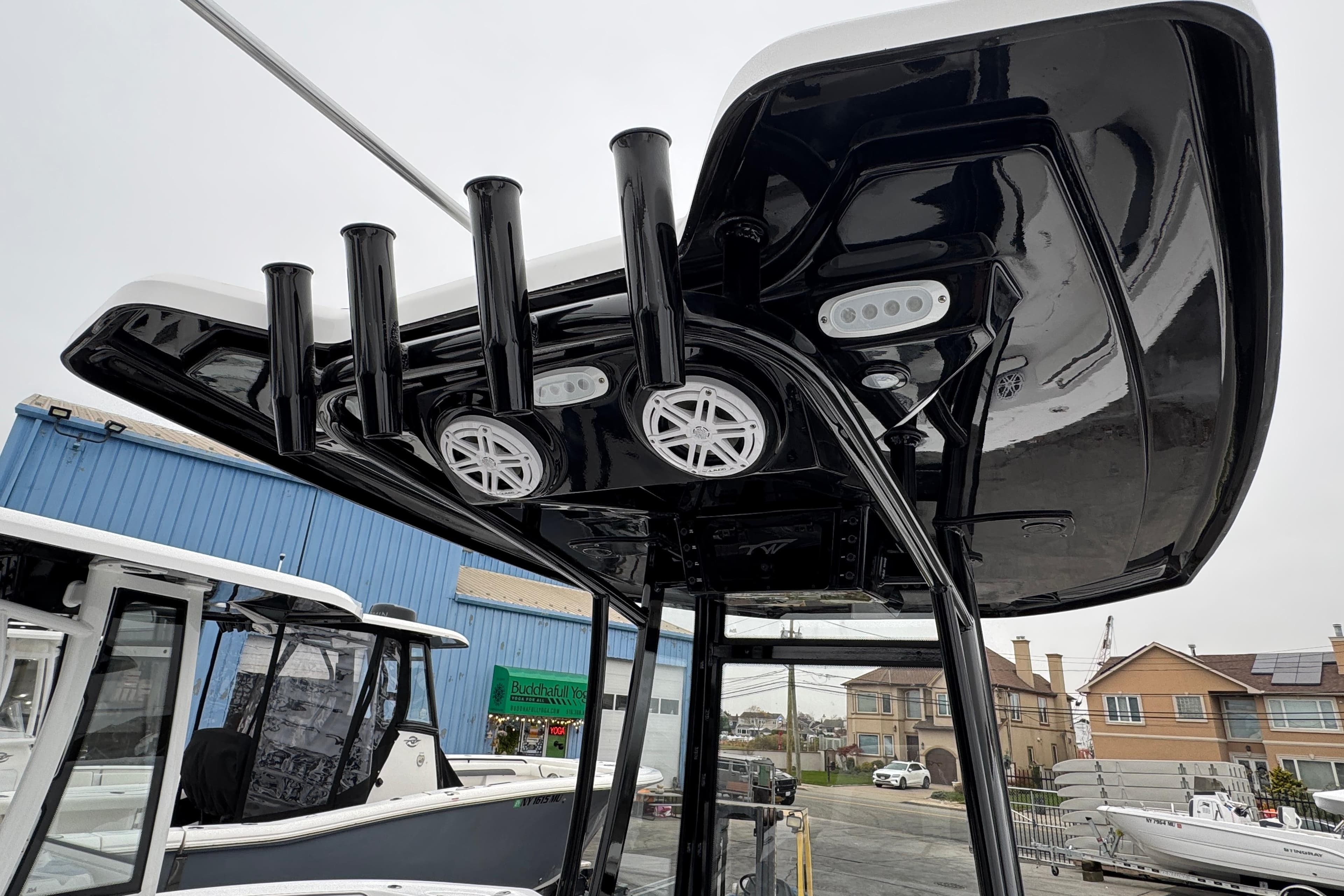 2026 Tidewater 210 CC Adventure boat with sleek black T-top and rod holders.