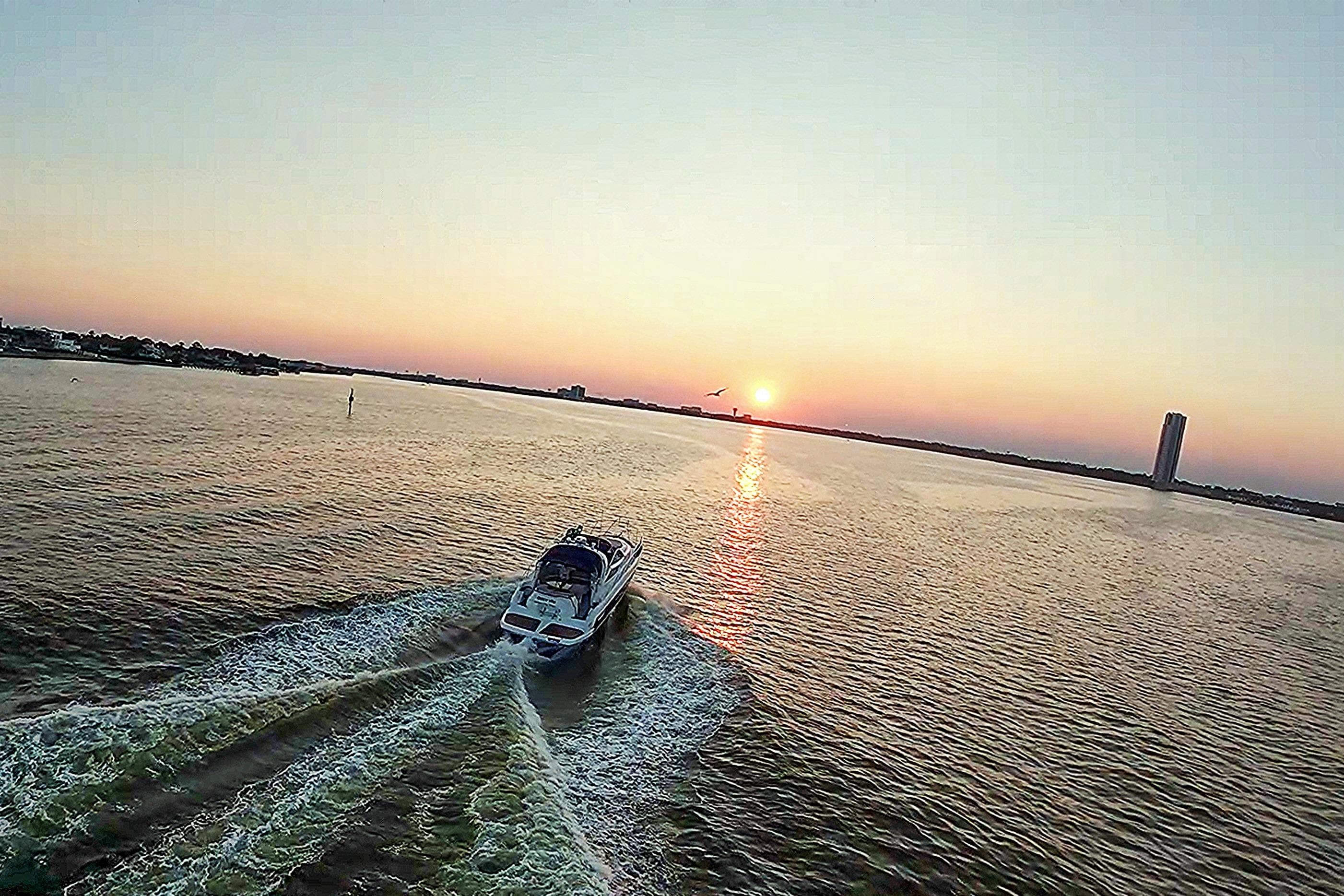 2008 Cranchi Mediterranee 43 yacht cruising at sunset on open water.