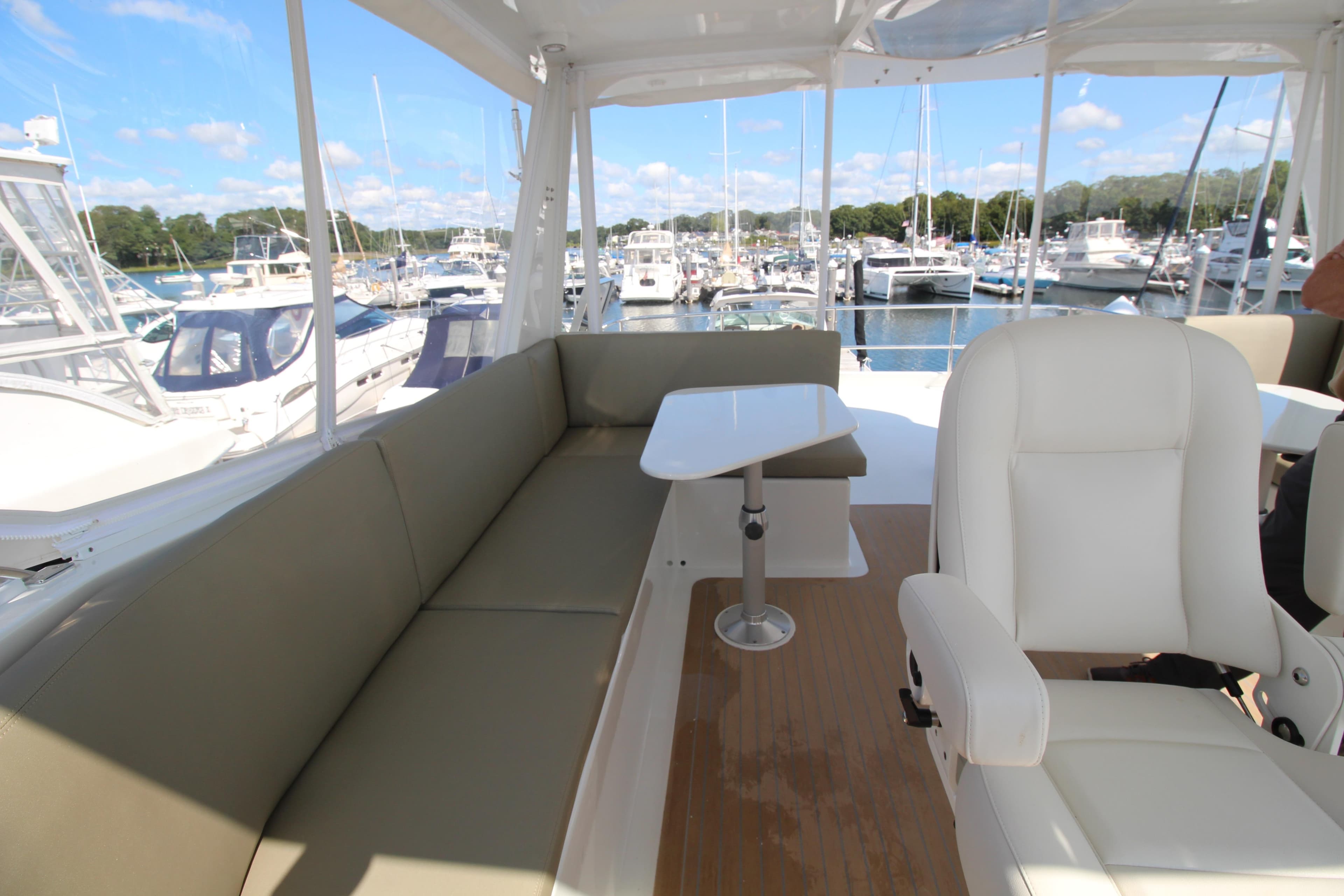 Luxurious seating area on 2026 Chris White Spindrift 47 yacht, docked at marina.