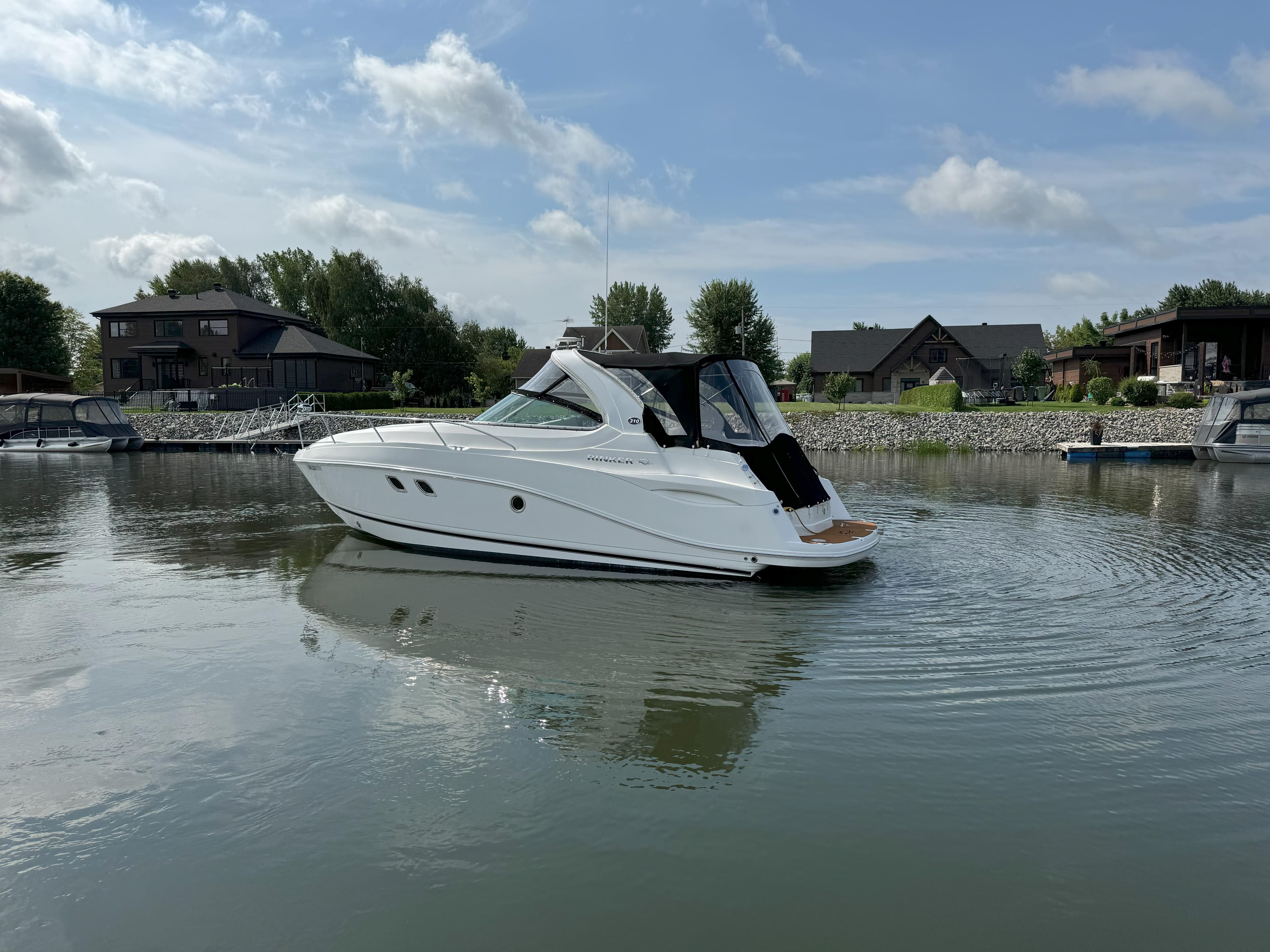 2010 Rinker 310 Express Cruiser on calm water.