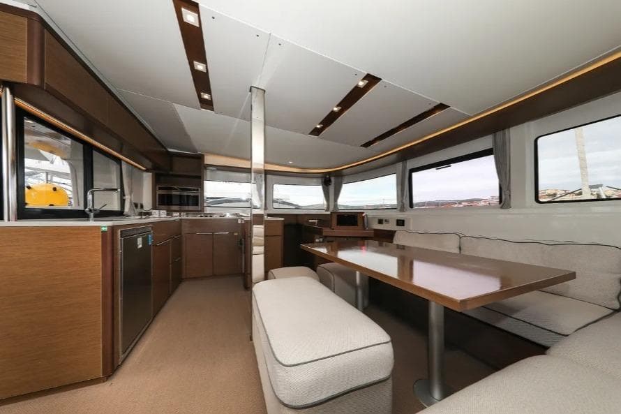 Interior of 2020 Lagoon 46 yacht with modern kitchen and dining area.