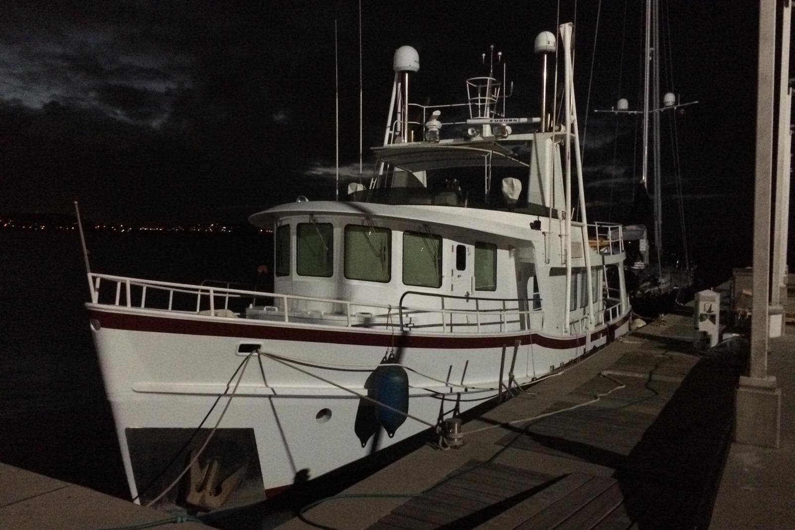 1992 Jones-Goodell 65’ Long Range Trawler docked at night.