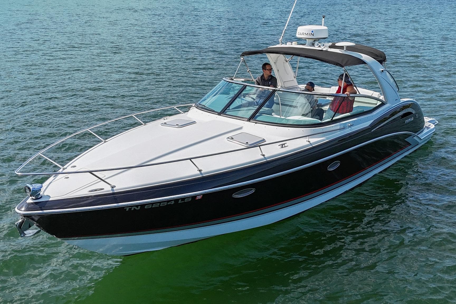 2014 Formula 350 Sun Sport boat cruising on calm water with passengers onboard.