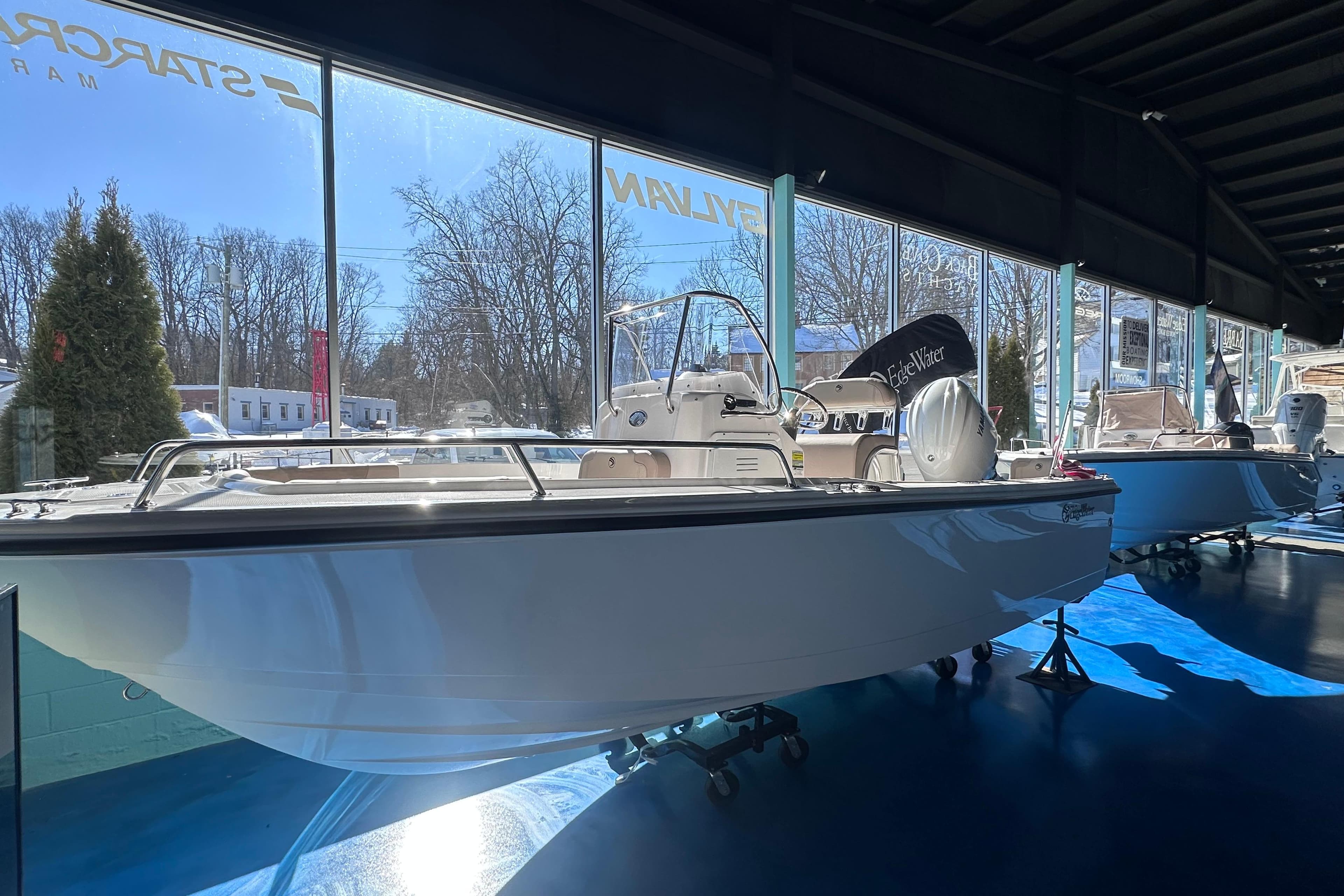 2026 Edgewater 188CC boat displayed in a showroom with large windows.
