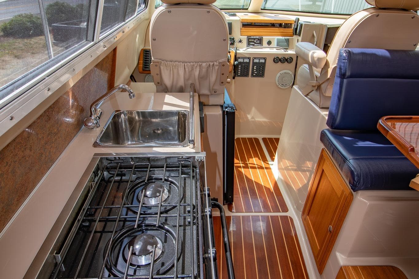Interior of 2013 Aspen C90 boat with kitchen, stove, and seating area.