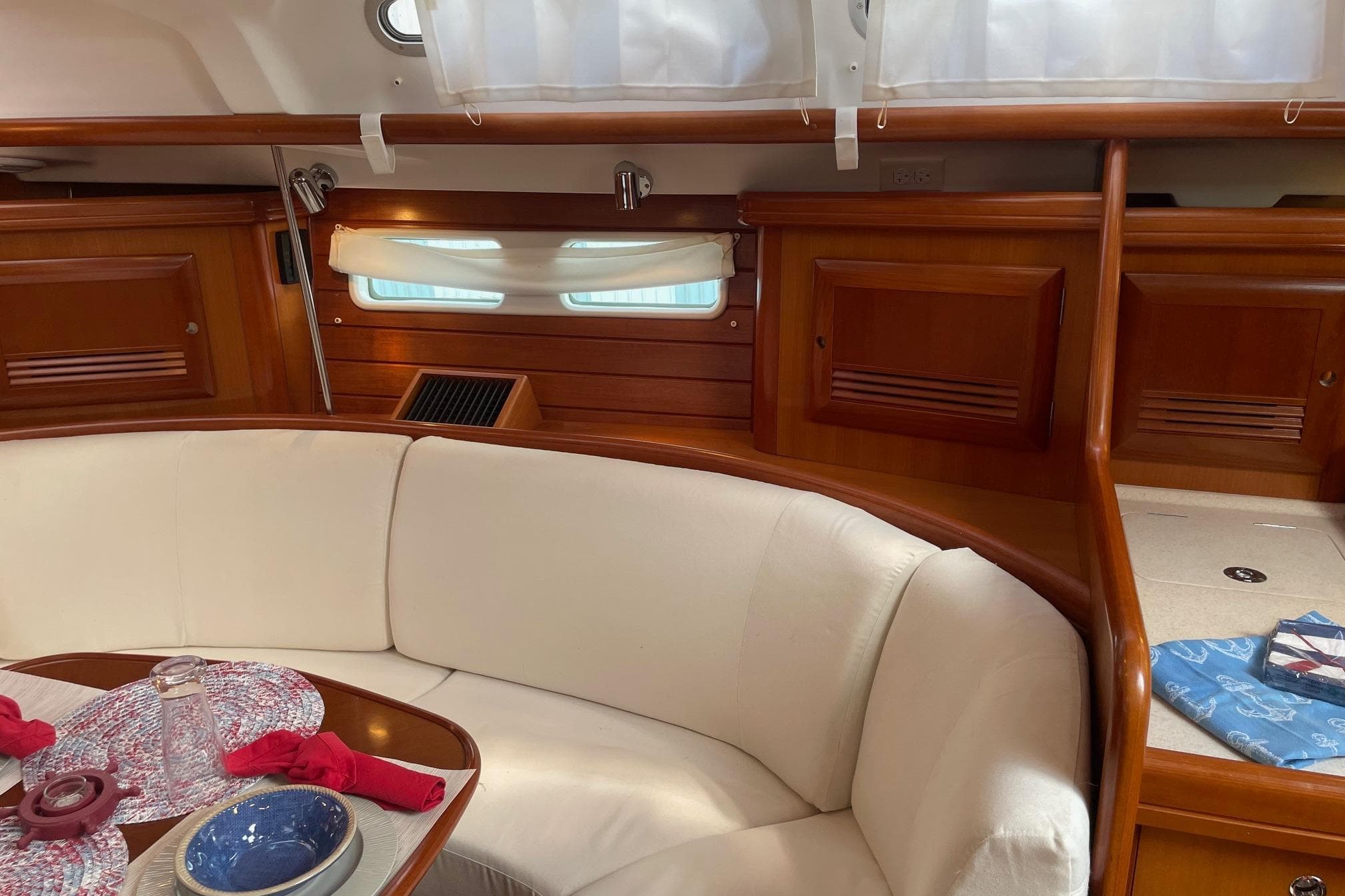 Interior of 2006 Beneteau Oceanis Clipper 423 with elegant wood finish and cozy seating.