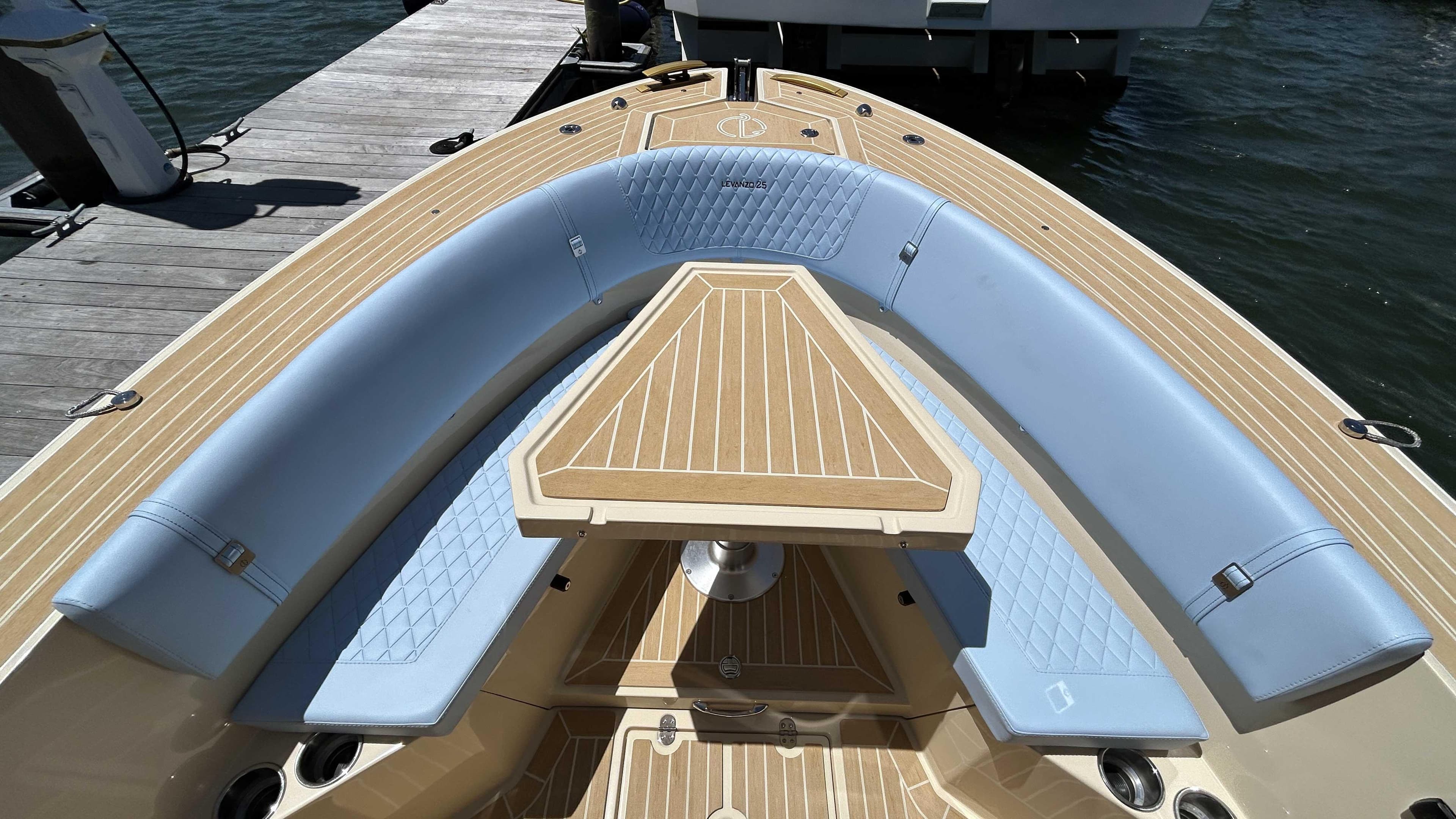Luxury Lilybaeum Levenzo 2025 boat with elegant seating and wooden deck at a dock.