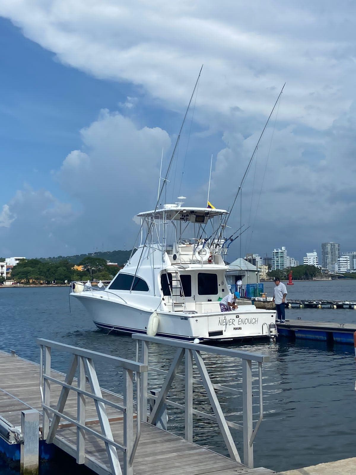 2005 Luhrs 38 Convertible yacht docked at a marina on a sunny day.