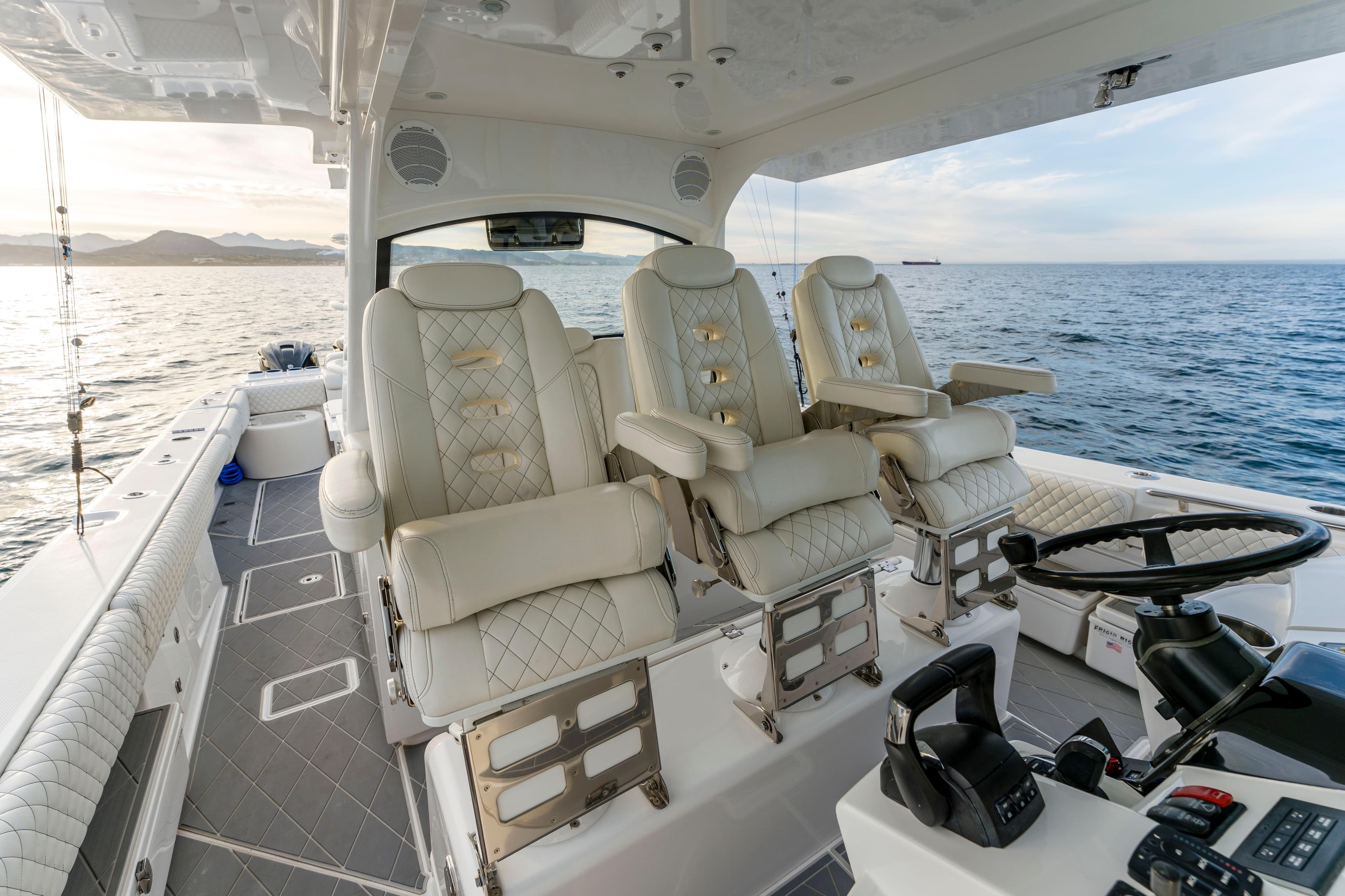 Luxury interior of 2022 HCB 53 Suenos RXV boat with plush seating and ocean view.