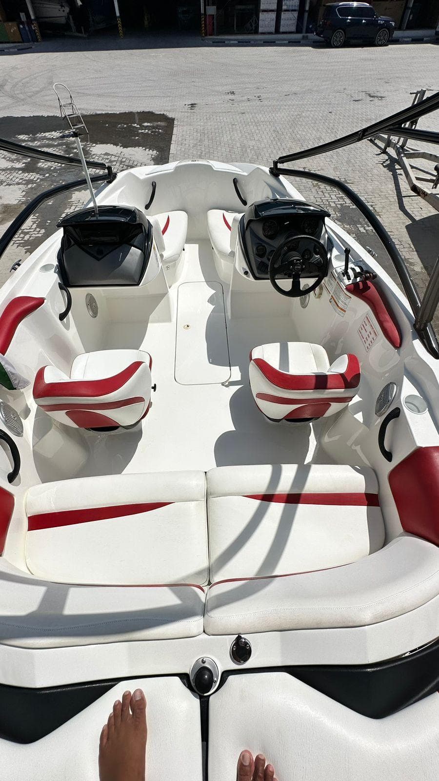 2011 Sea-Doo Sport Boats 210 Wake with red and white interior, docked on a sunny day.