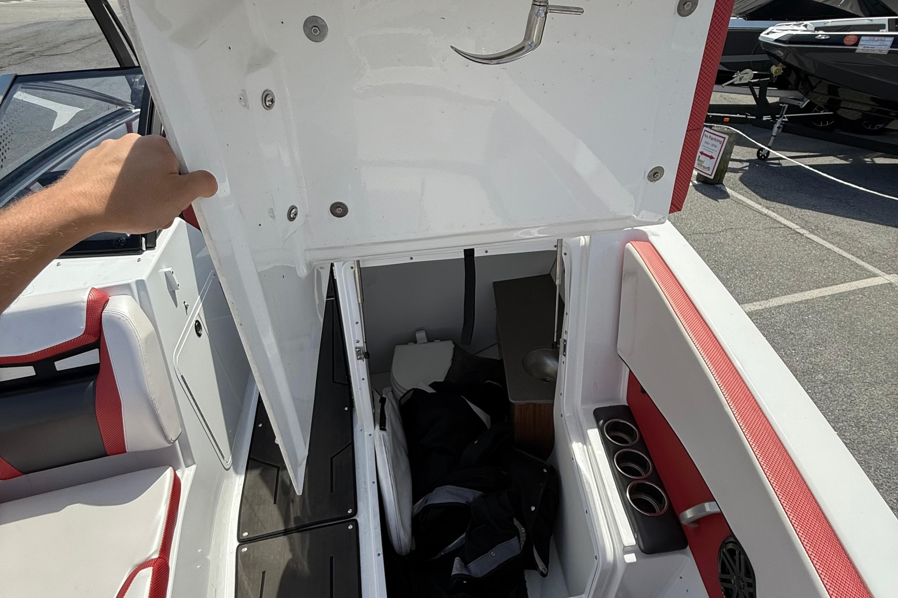 2022 Scarab 285 ID boat interior storage compartment with seating and cup holders.