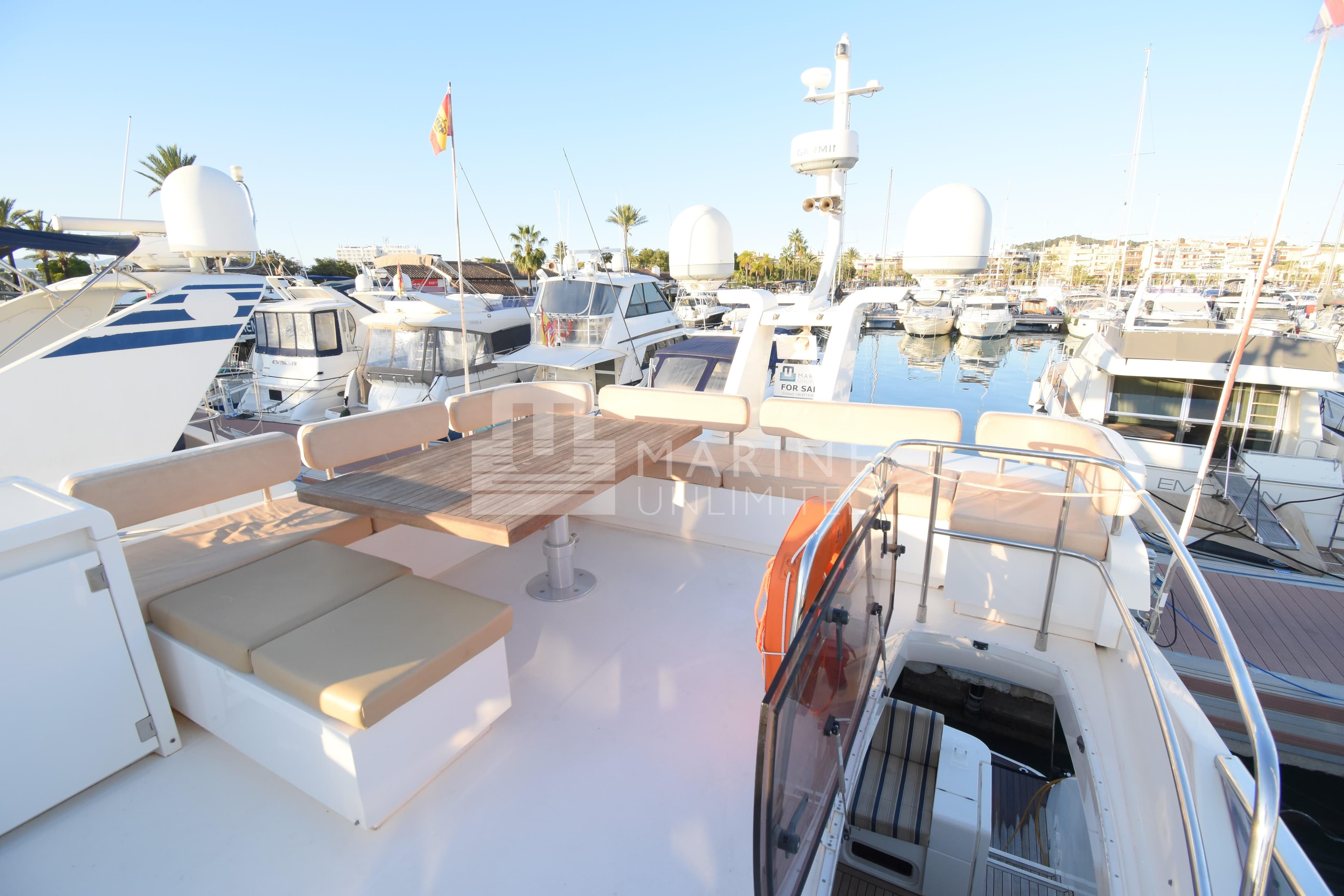 2010 Fairline Squadron 55 yacht deck with seating area in marina.