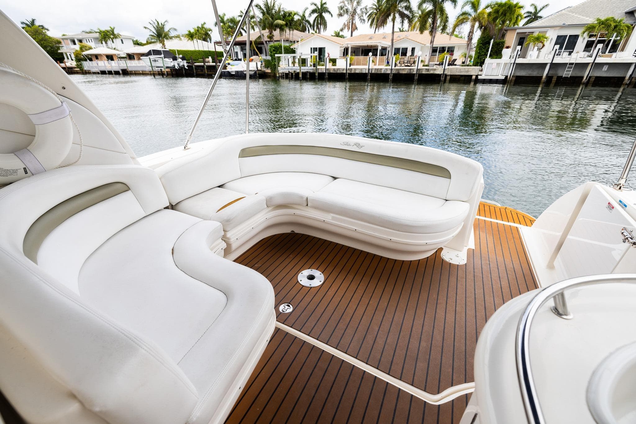 Luxurious 2007 Sea Ray 340 Sundancer boat interior with white seating and wooden deck.