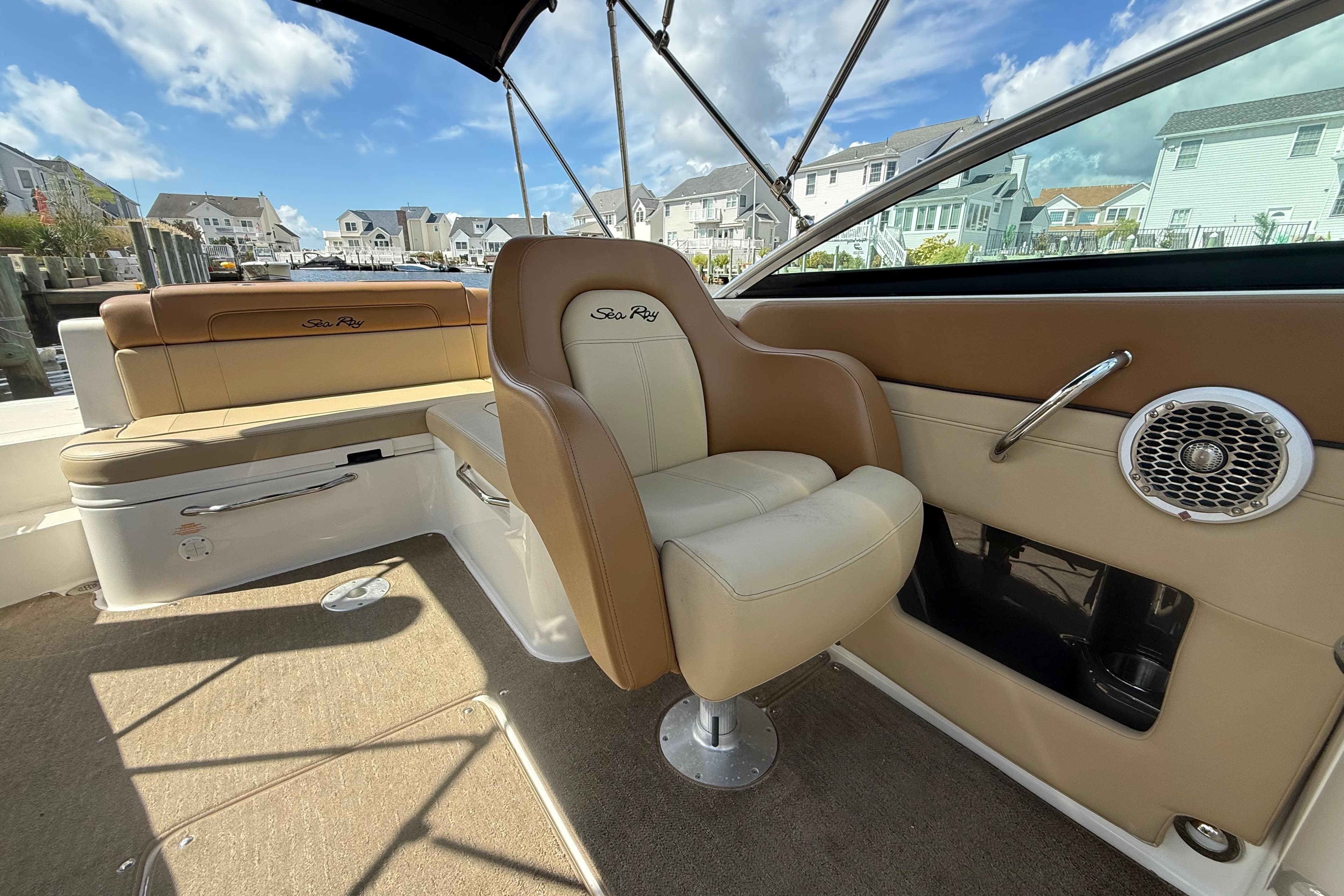 2014 Sea Ray 260 Sundeck interior with tan seating and waterfront view.