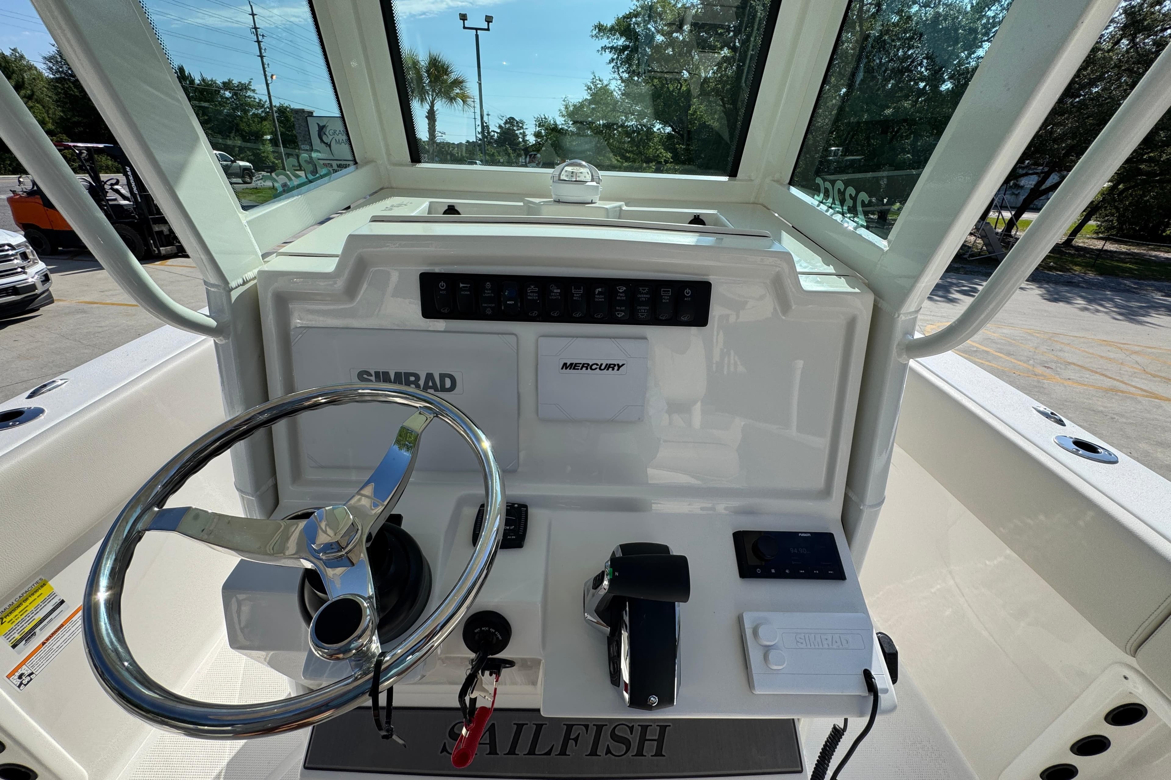 2026 Sailfish 232 CC boat dashboard with steering wheel and control panel.