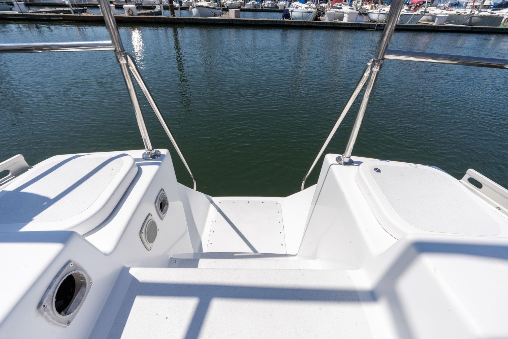 Stern view of 1978 Cascade High Side boat docked at marina.