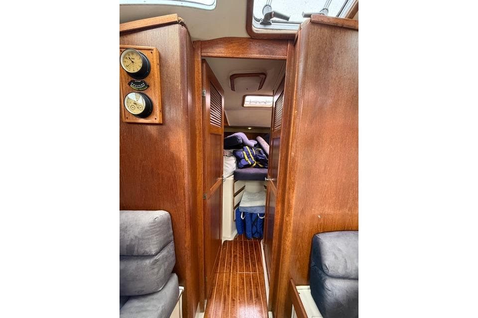 Interior of 1987 Irwin 38 Mk II sailboat with wooden paneling and cozy cabin space.