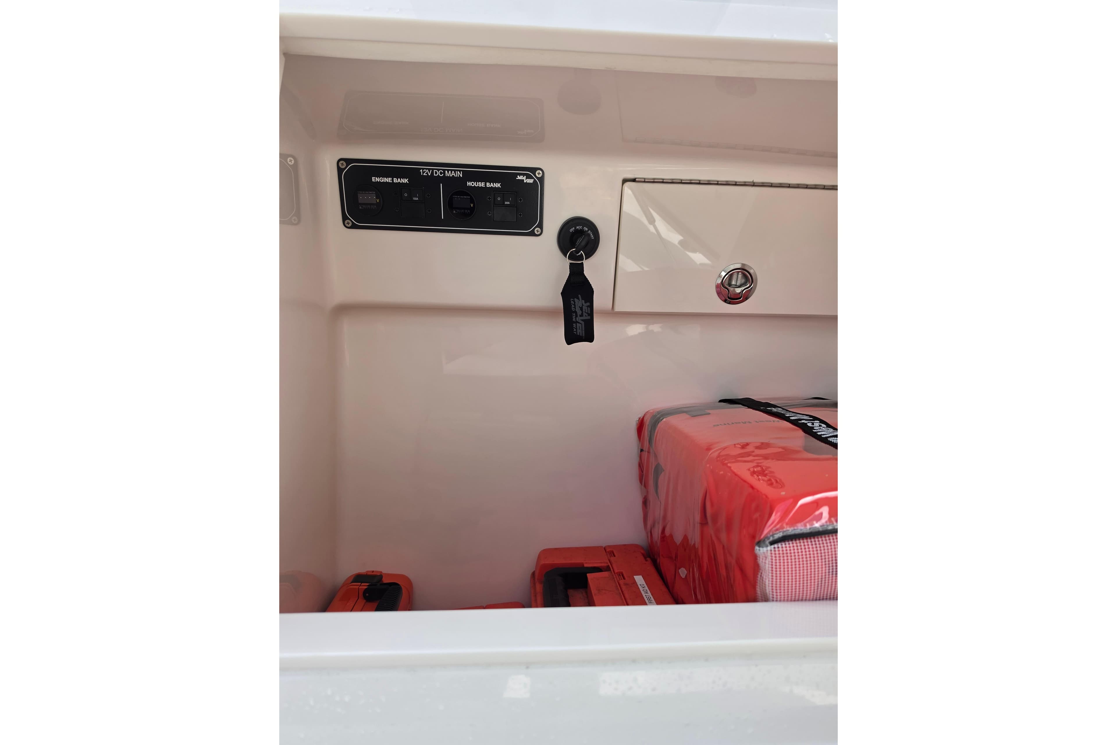 Interior view of 2025 SeaVee 270Z boat compartment with electrical panel and safety equipment.