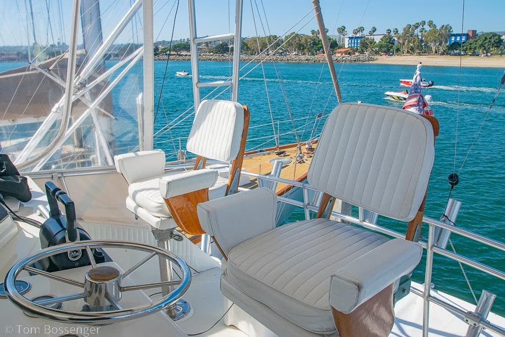 Helm of 1989 Bertram 50 Convertible yacht with ocean view and plush seating.