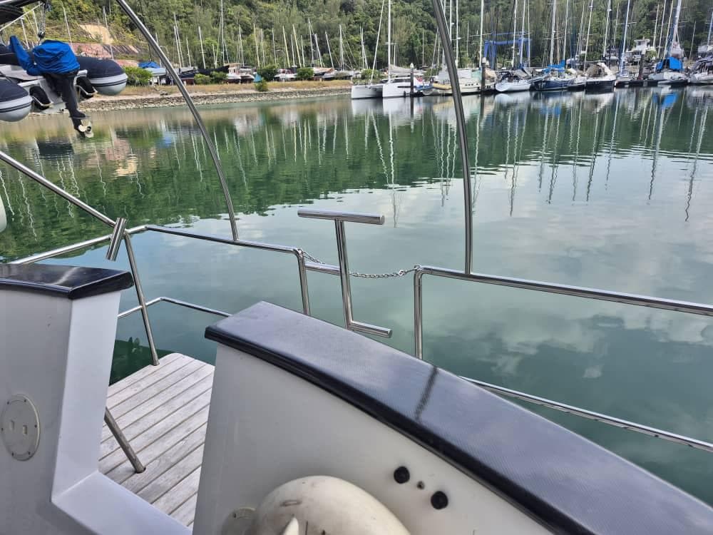 Nordhavn 46 yacht docked in a serene marina, surrounded by sailboats, 1994 model.