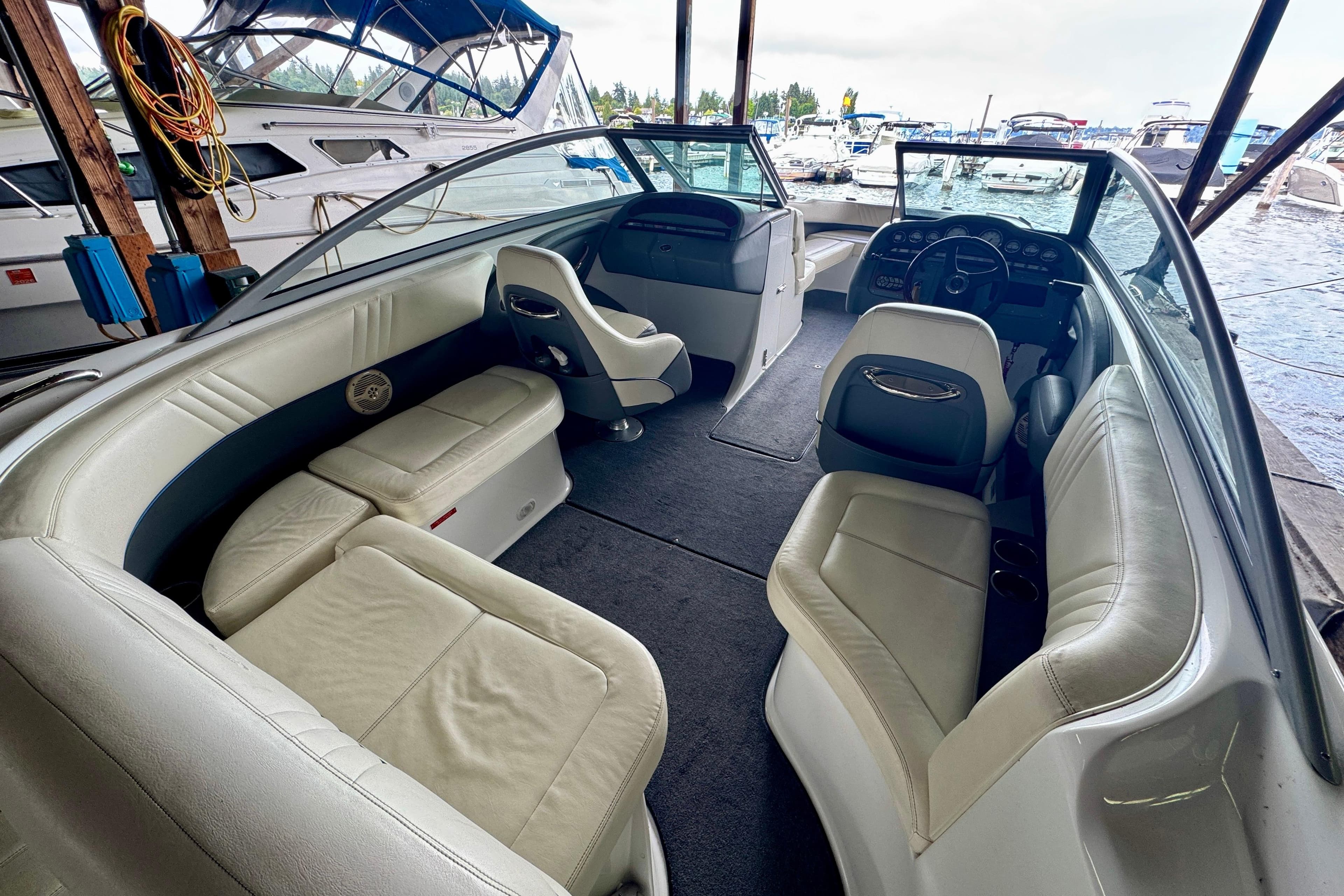 Interior of a 2006 Cobalt 232 boat with white seating and dashboard view.