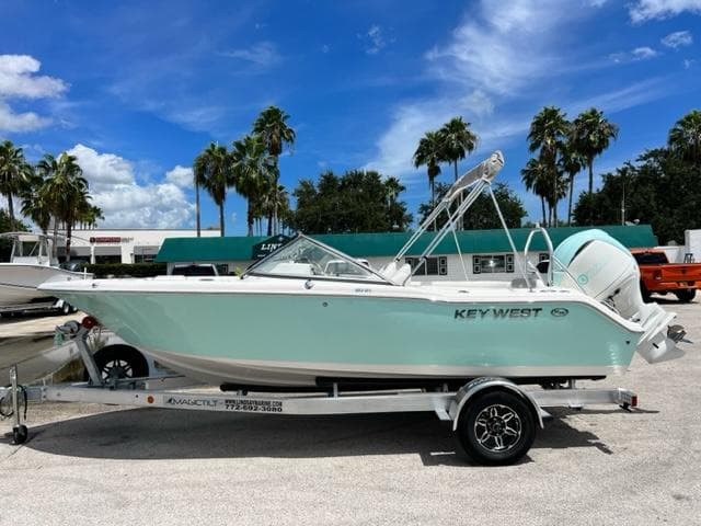 2024 Key West 203 DFS boat on trailer, palm trees in background.