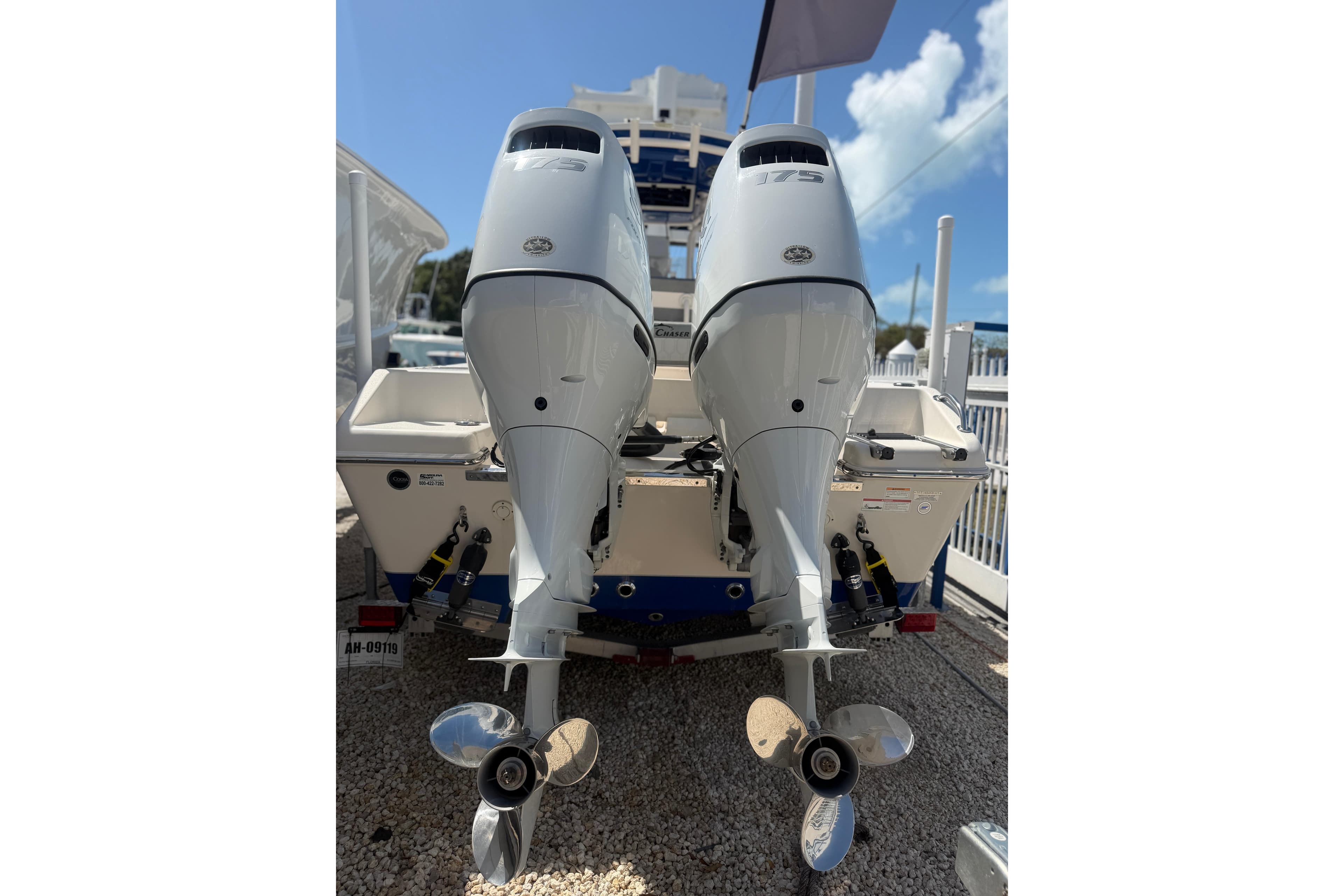 2023 Sea Chaser 24 HFC boat with dual outboard motors, rear view.