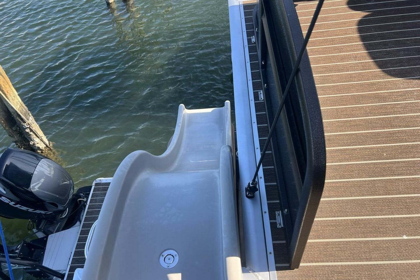 2023 Premier 330 Escalante boat with slide and motor on water.