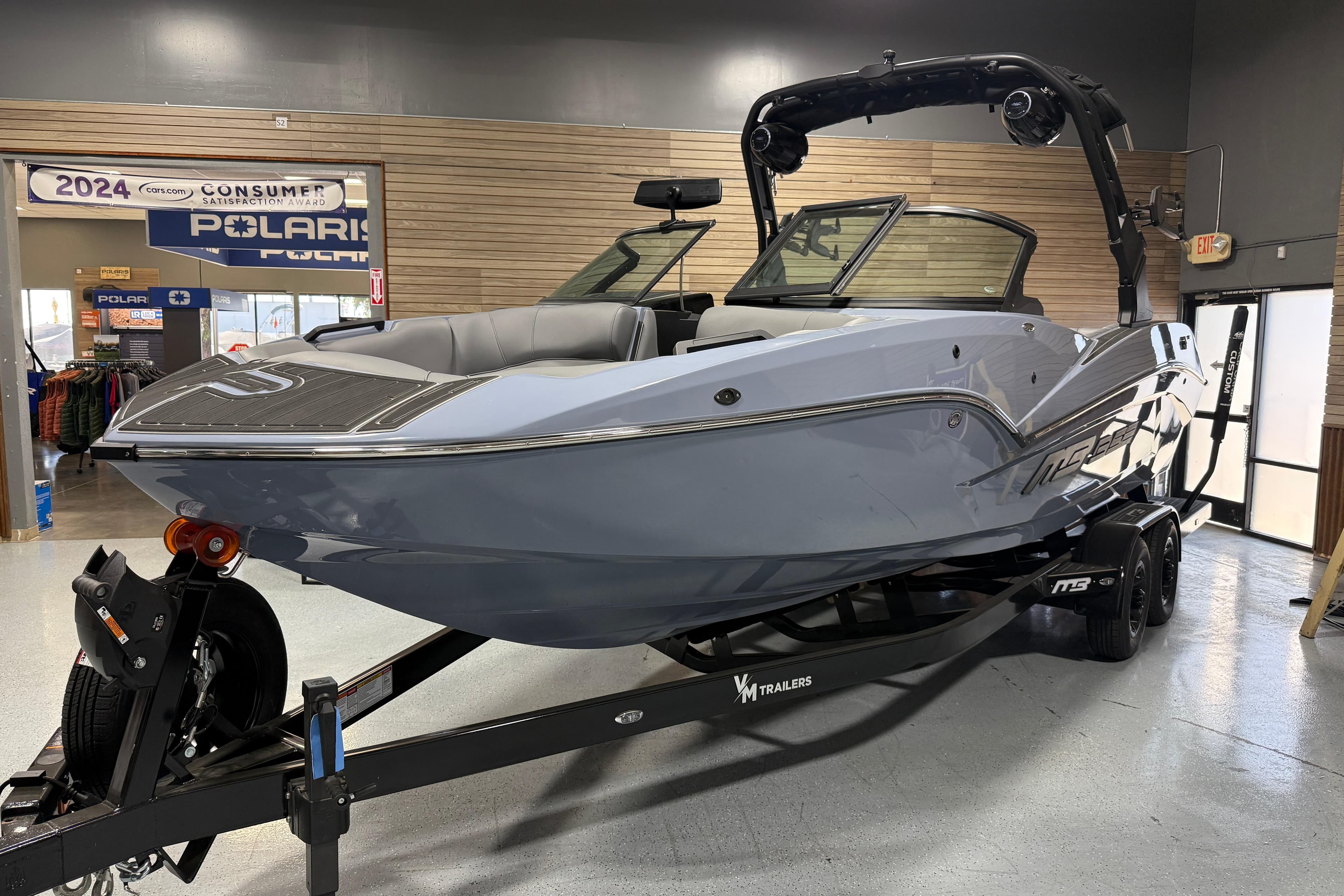 2026 MB B52 23 Alpha boat displayed indoors on a trailer.